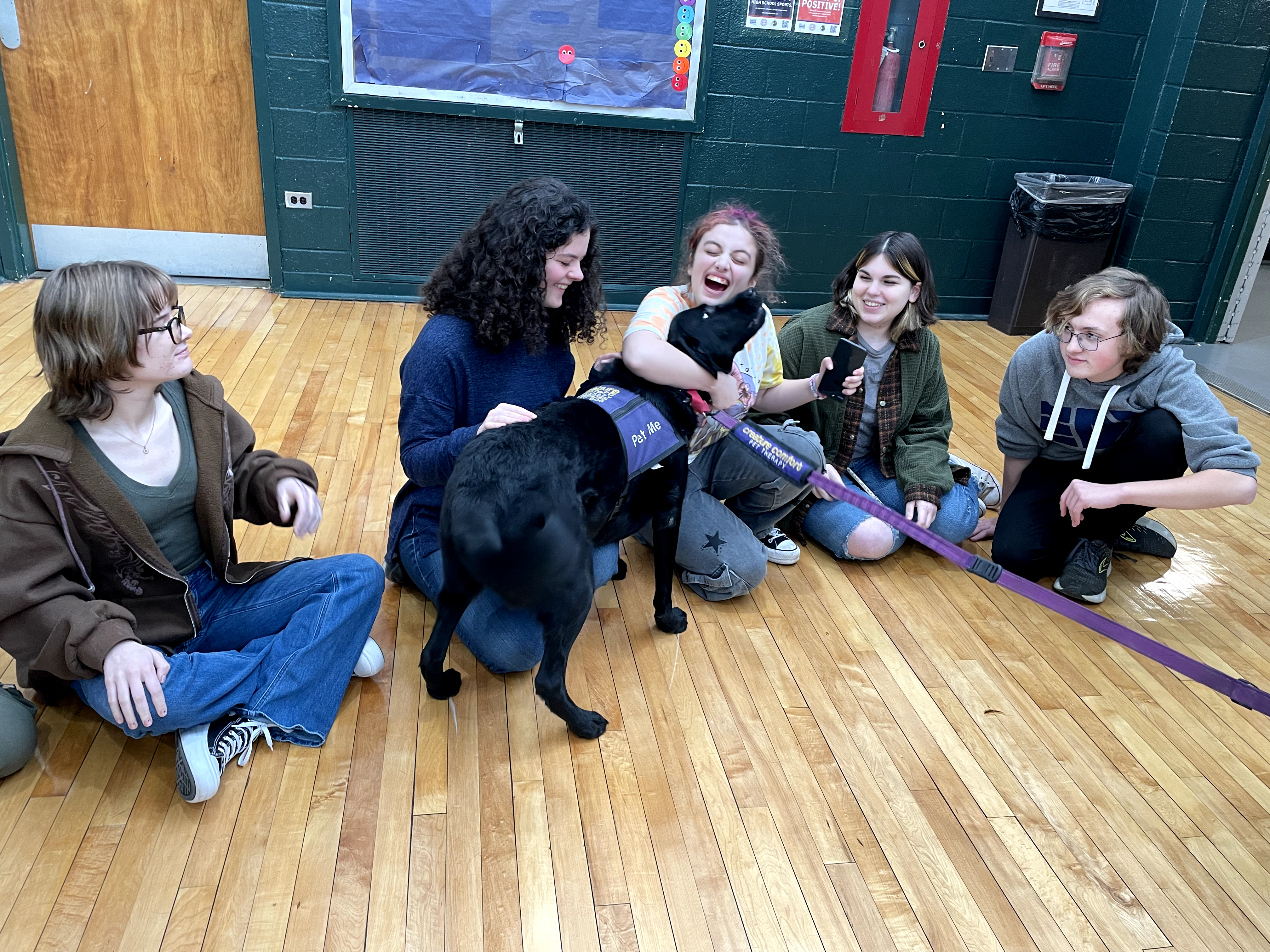 Therapy dog with students at NPHS