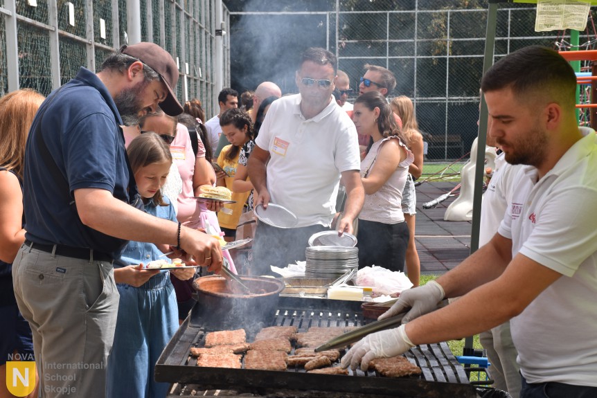 Parent volunteers grilling food at the PTA barbecue