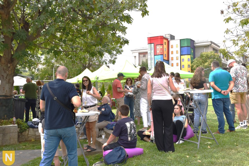 Families mingling on the school lawn at the BBQ social