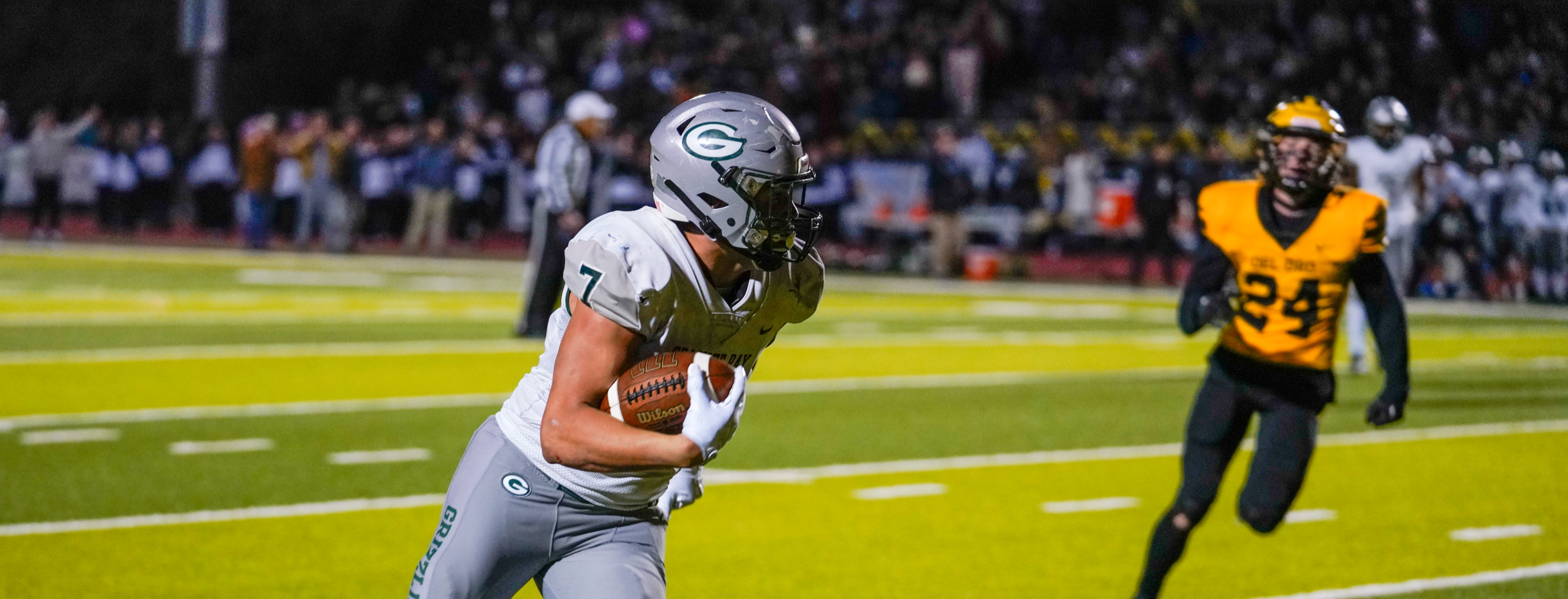 Football player runs with ball in hand