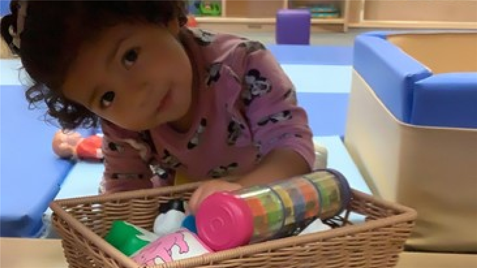 Girl playing under desk