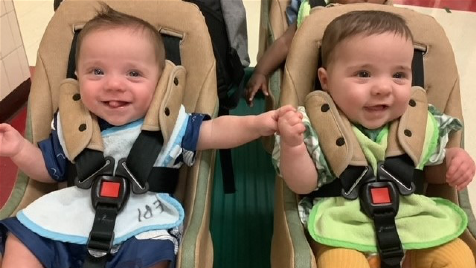 Babies holding hands