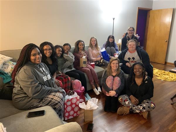 group of cheerleaders seated in hotel