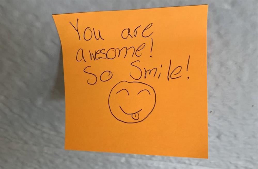 Post-It with a smiley face and the message "You are awesome, so smile!"