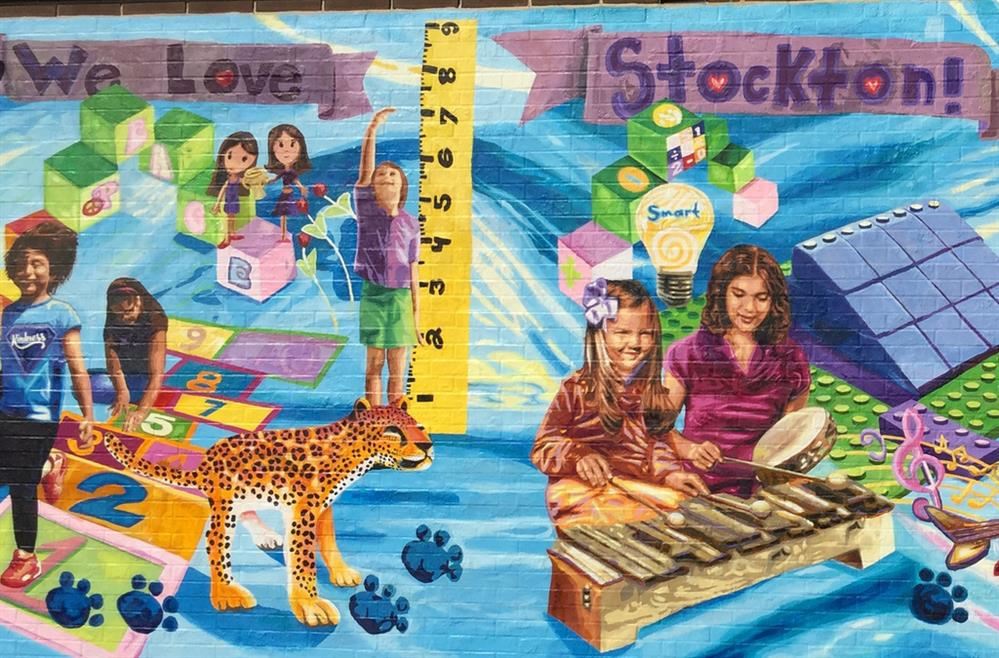 We are Stockton! Painting mural on side of building.