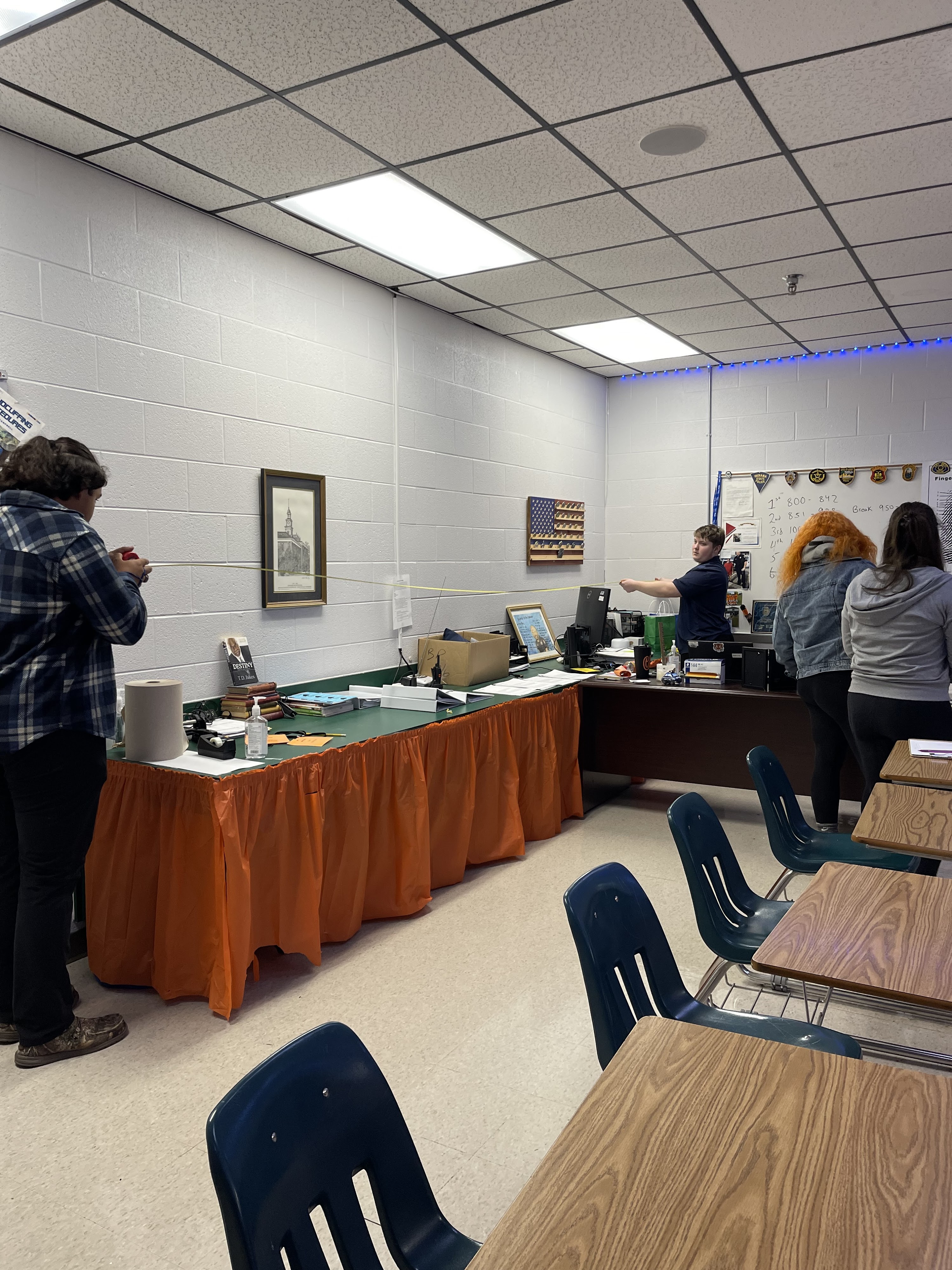 students taking measurements of classroom