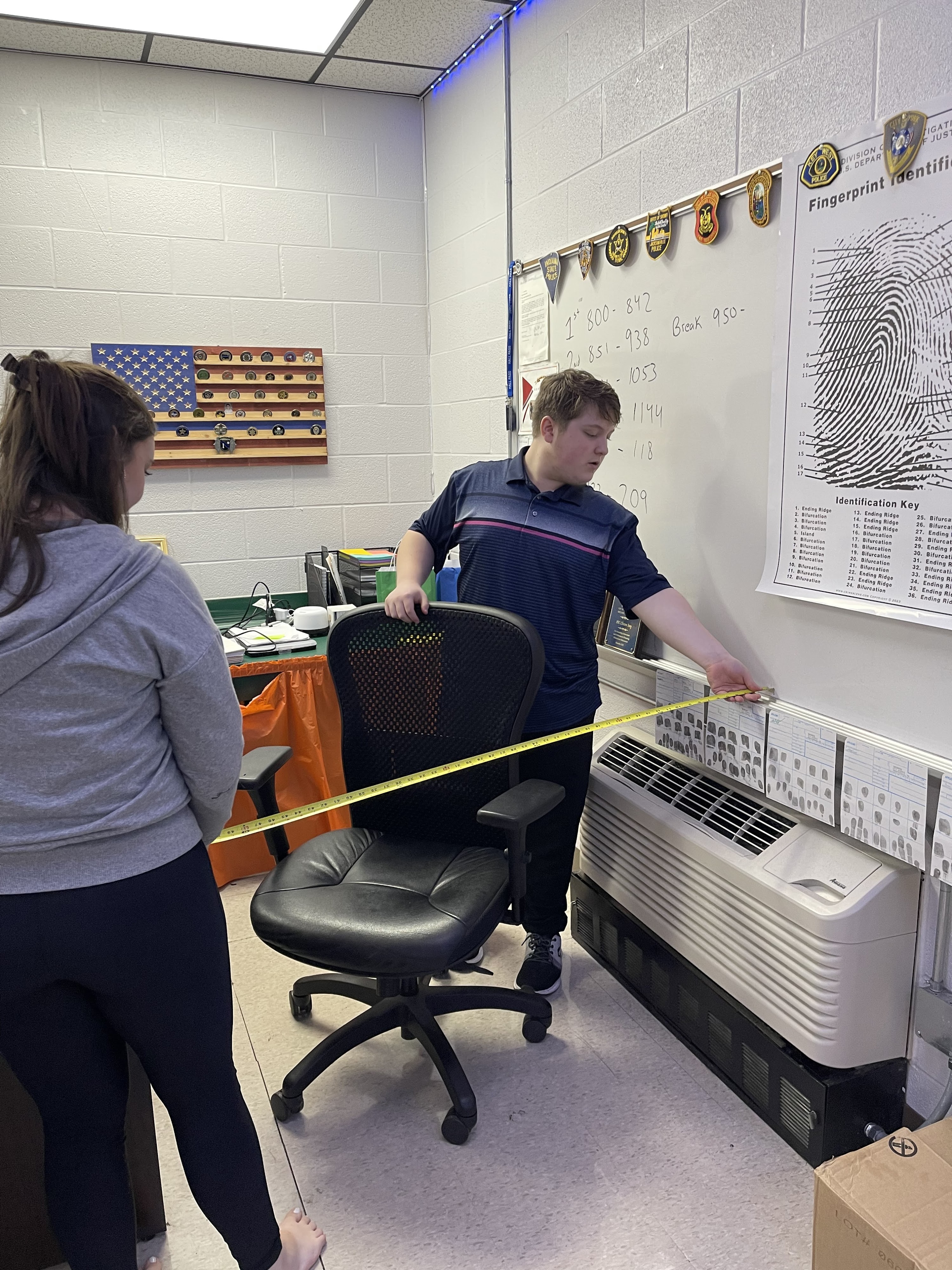 students taking measurements of classroom