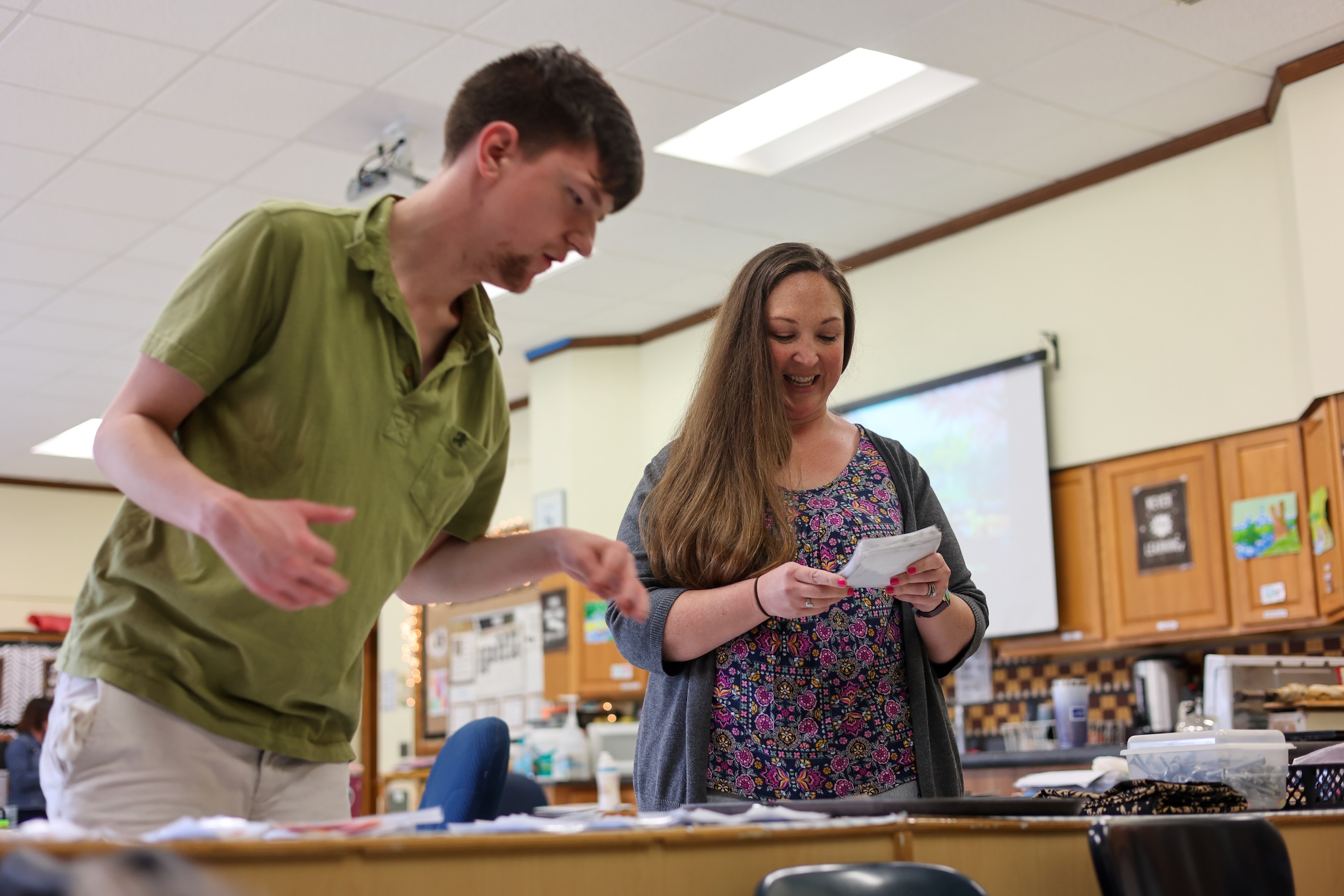 Teacher working with student.