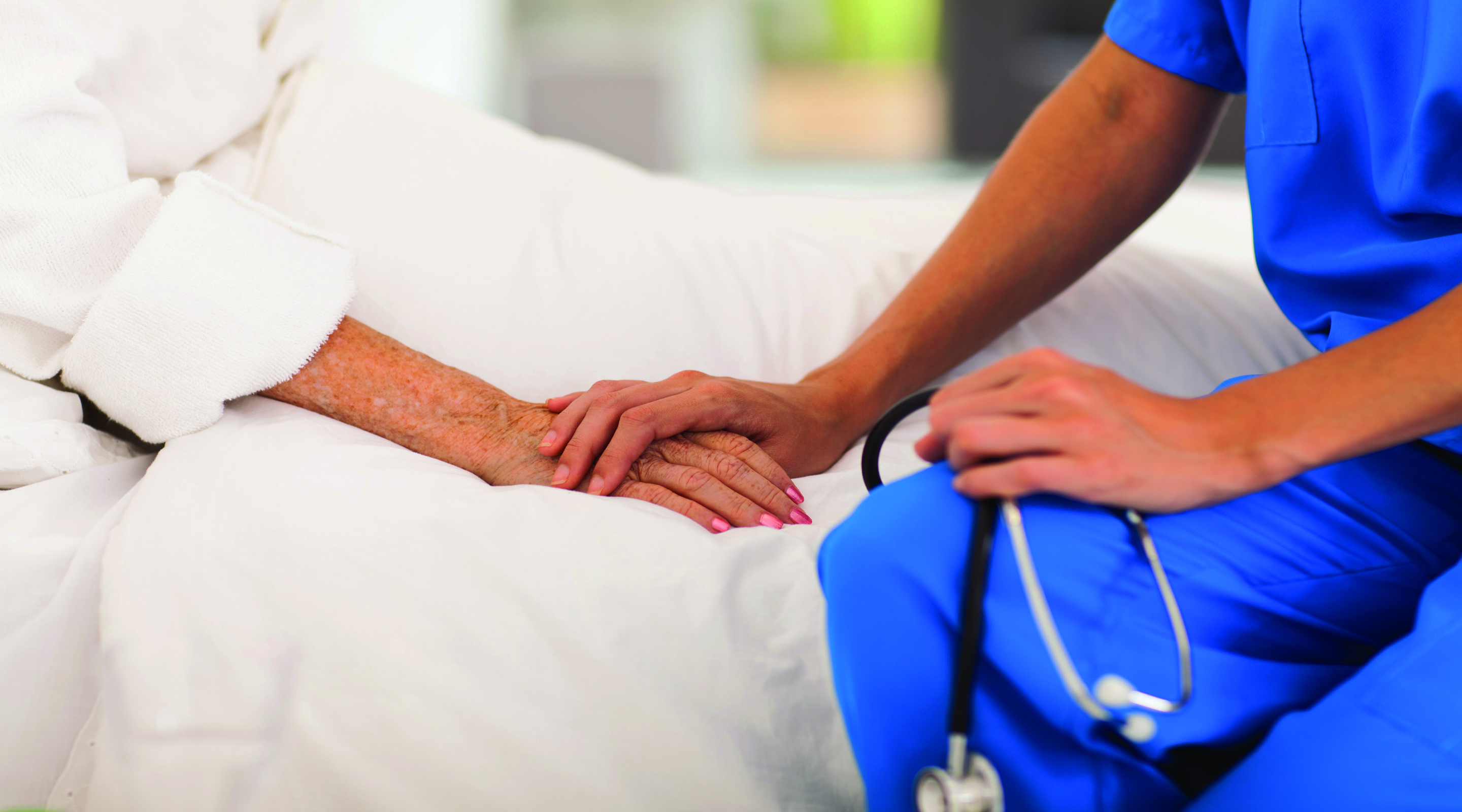 A Nurse Holding Older Patients Hand
