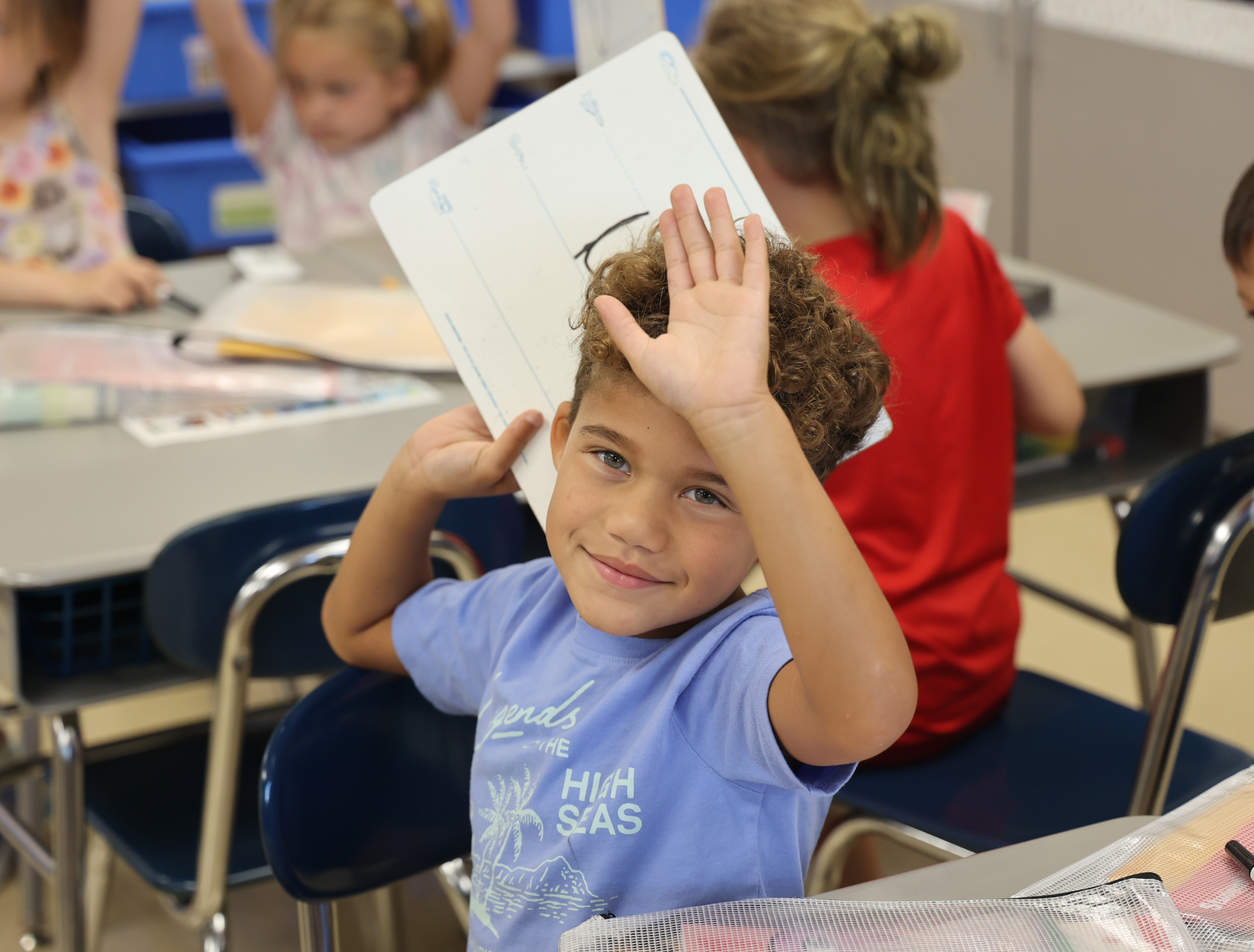 photo of student holding whiteboard