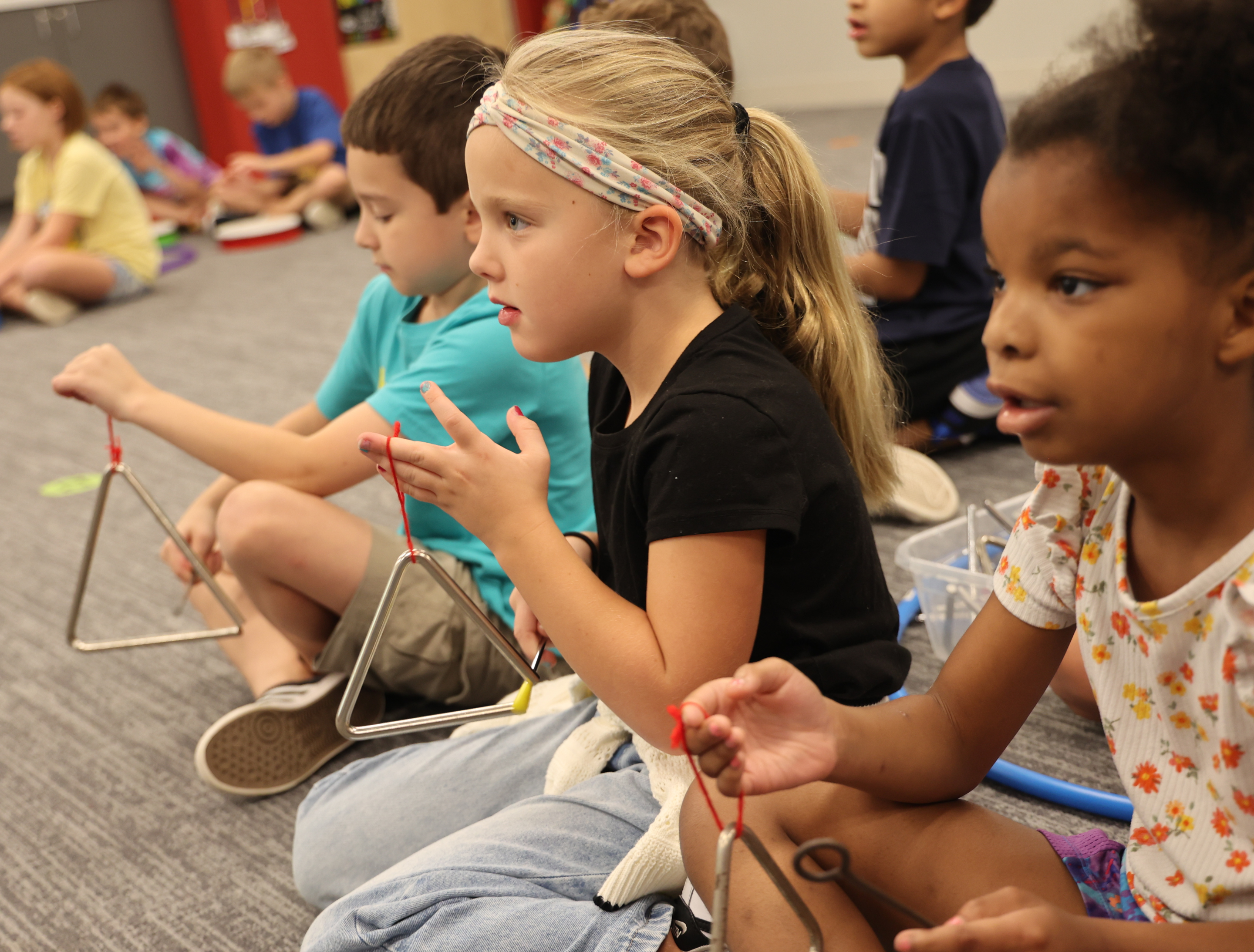 photo of students playing the triangle