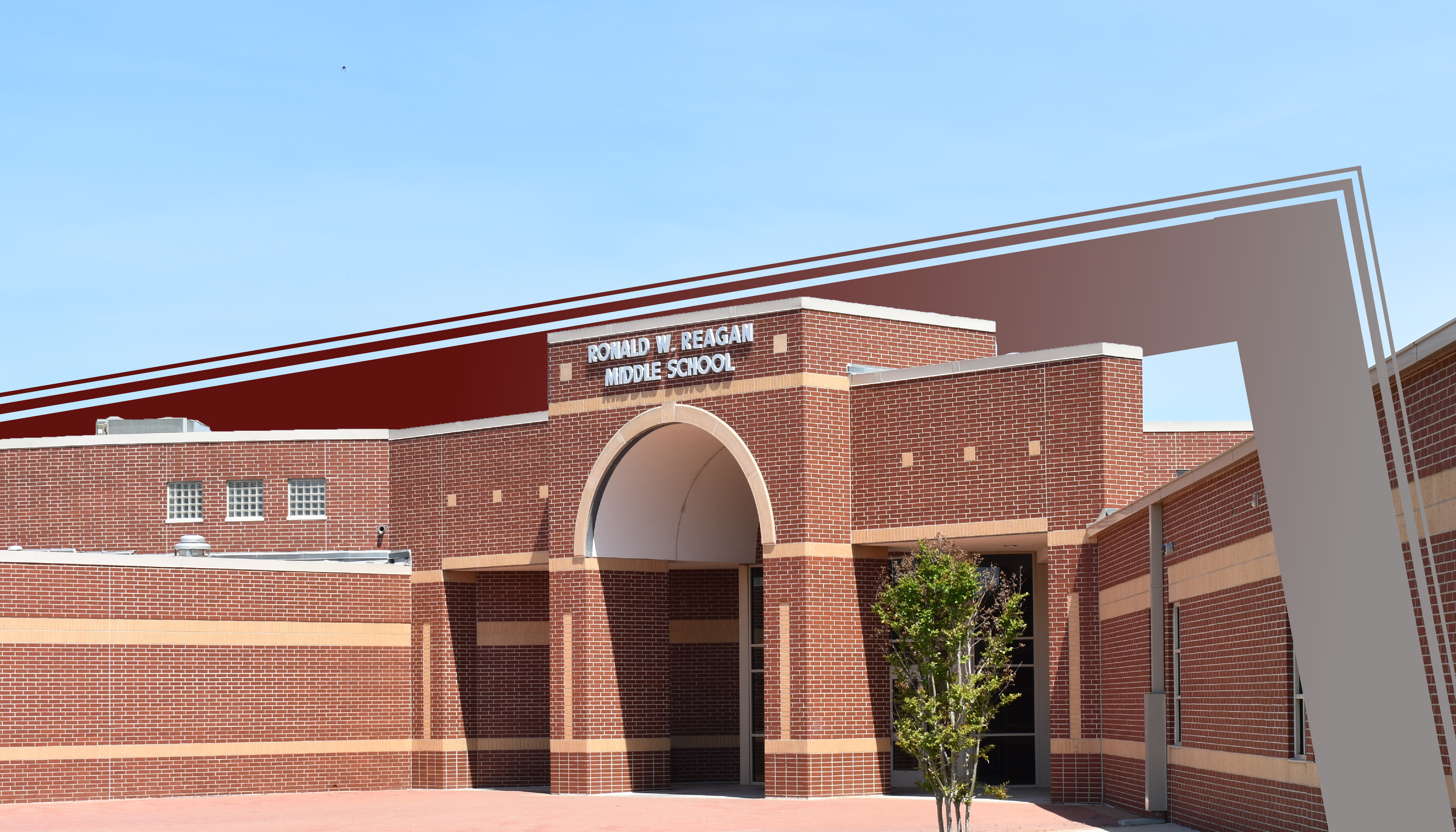 A large brick building with an arched entryway and a sign that reads "Dwight D. Eisenhower High School" against a clear blue sky.
