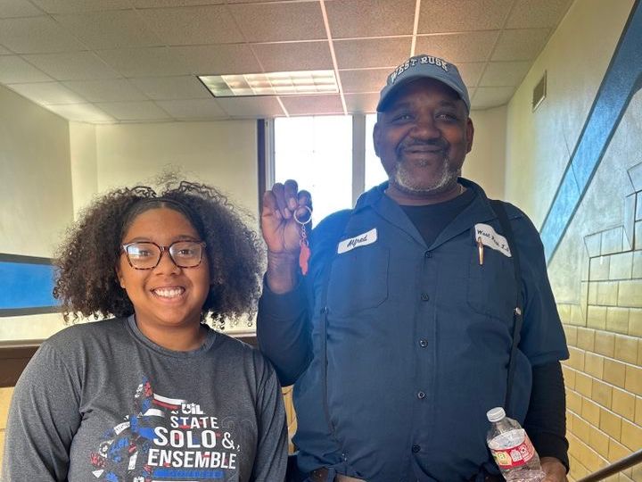 West Rusk High School student standing next to a man holding a small award