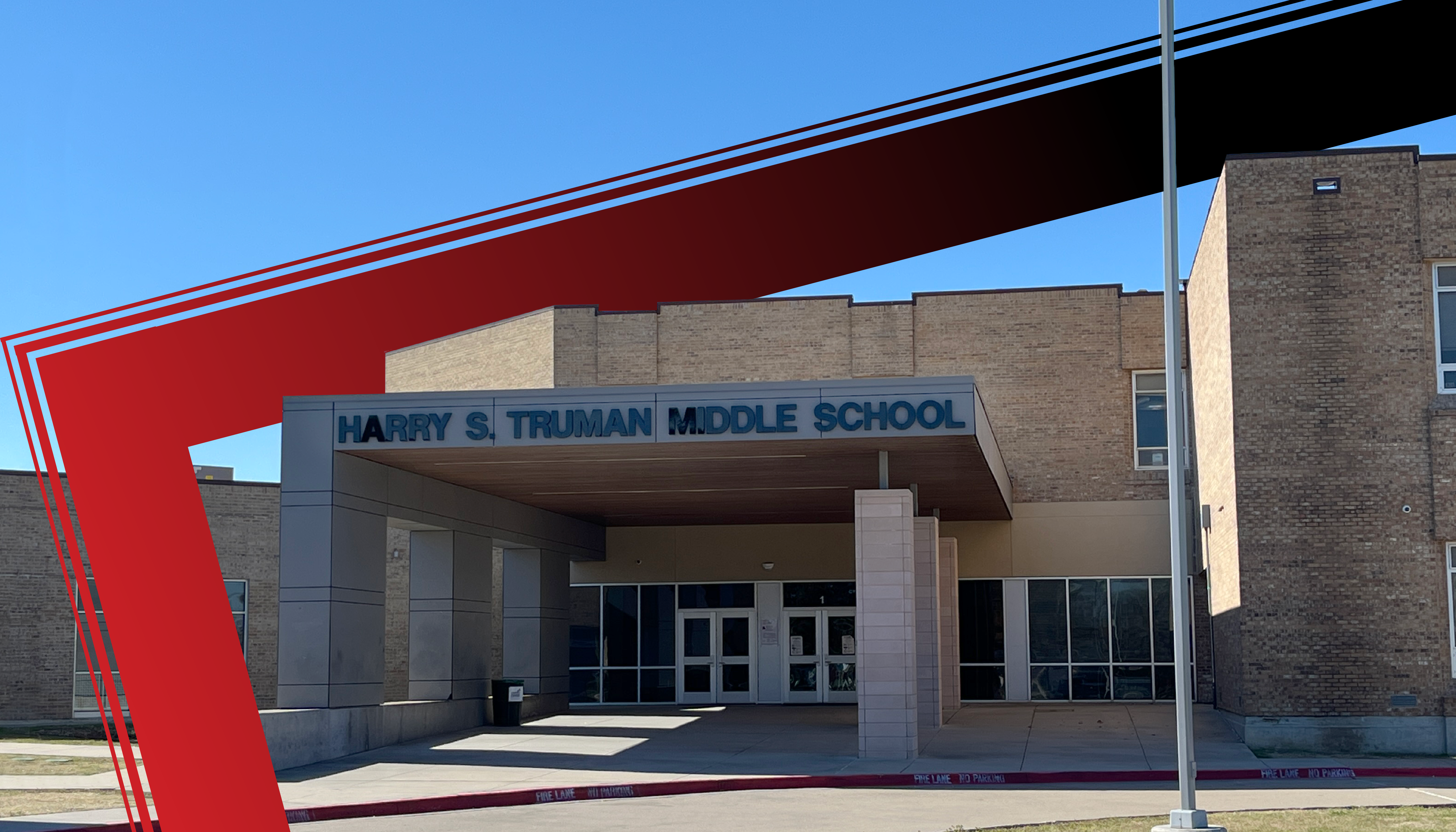 A modern, red-accented building with the name "Harry S. Truman Middle School" prominently displayed on the facade, set against a clear blue sky.