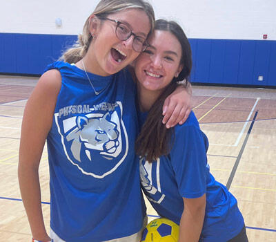 Two students hugging in a PE class