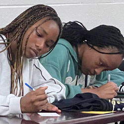 Students taking notes in a class
