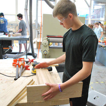 Student working in a woods class