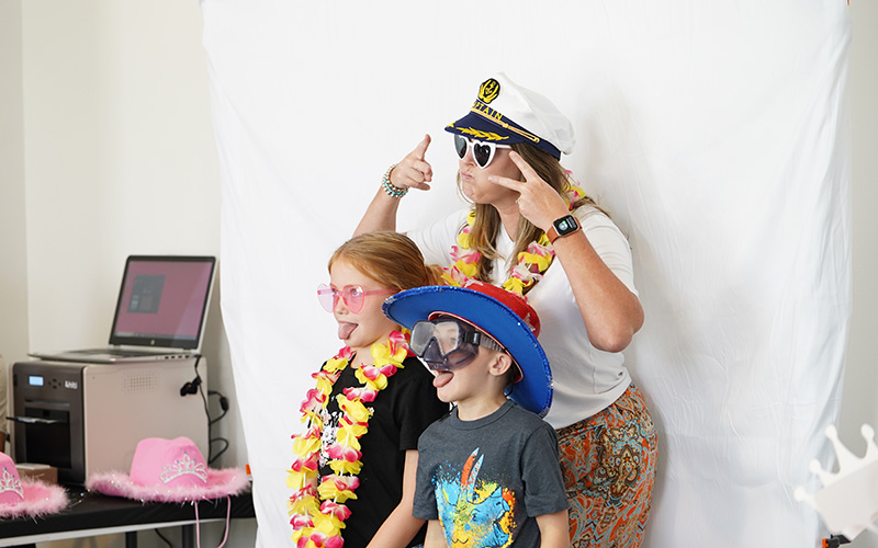 Family takes a picture together at a photobooth at STEMfest 2024
