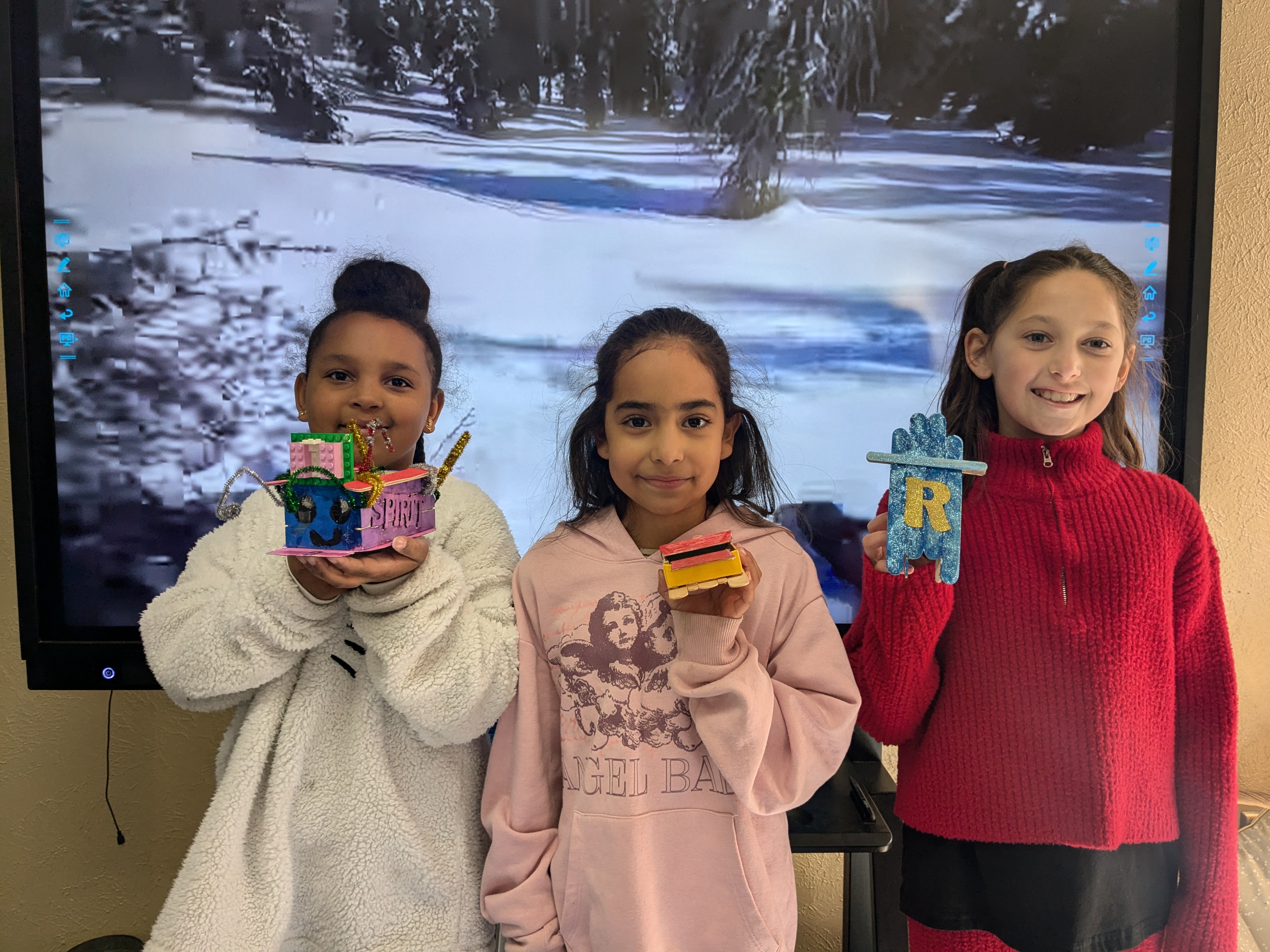 West Rusk Intermediate students hold up homemade sleds.