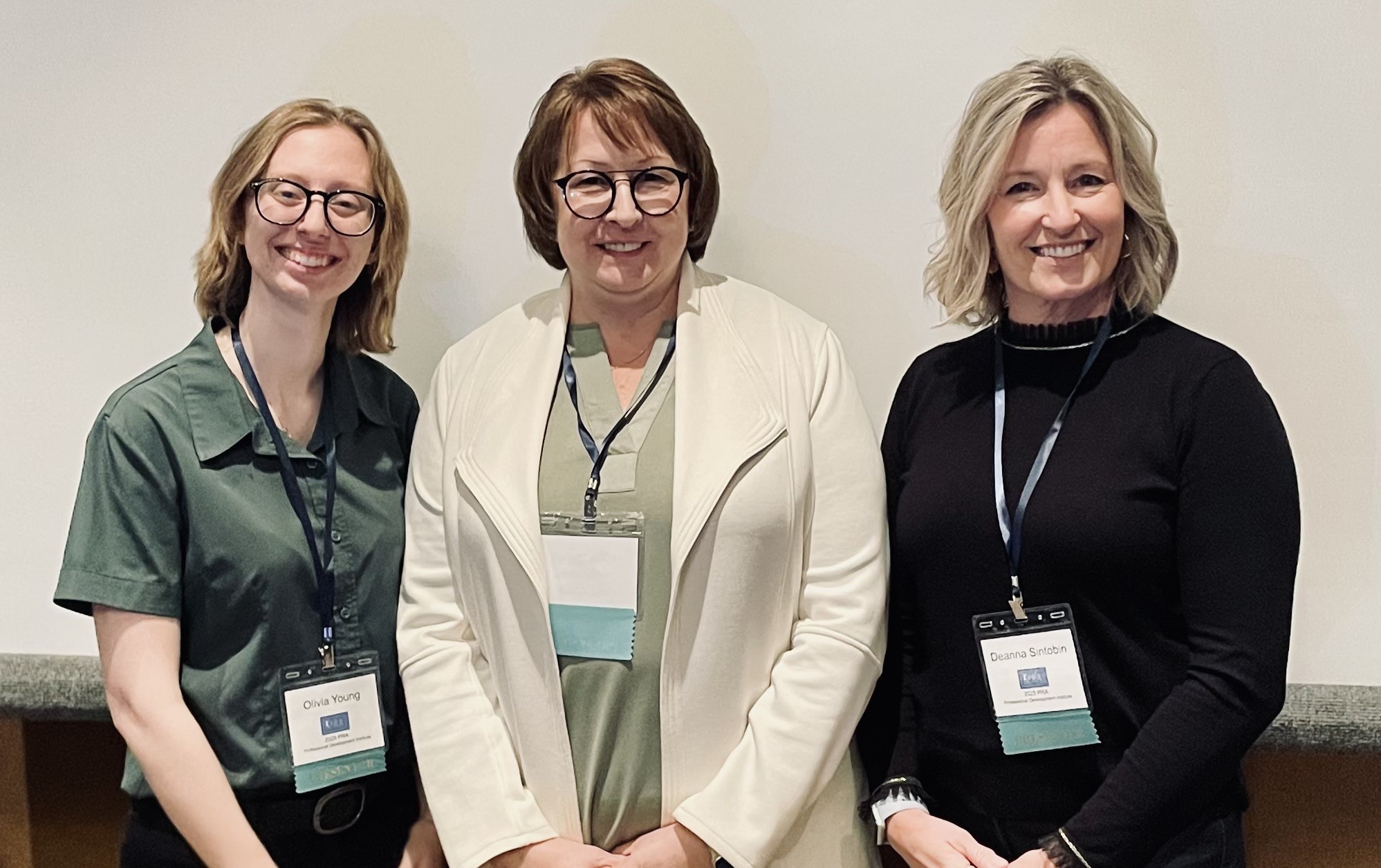 Three woman pose for a phot after presenting at the PA Rehabilitation Association Institute.