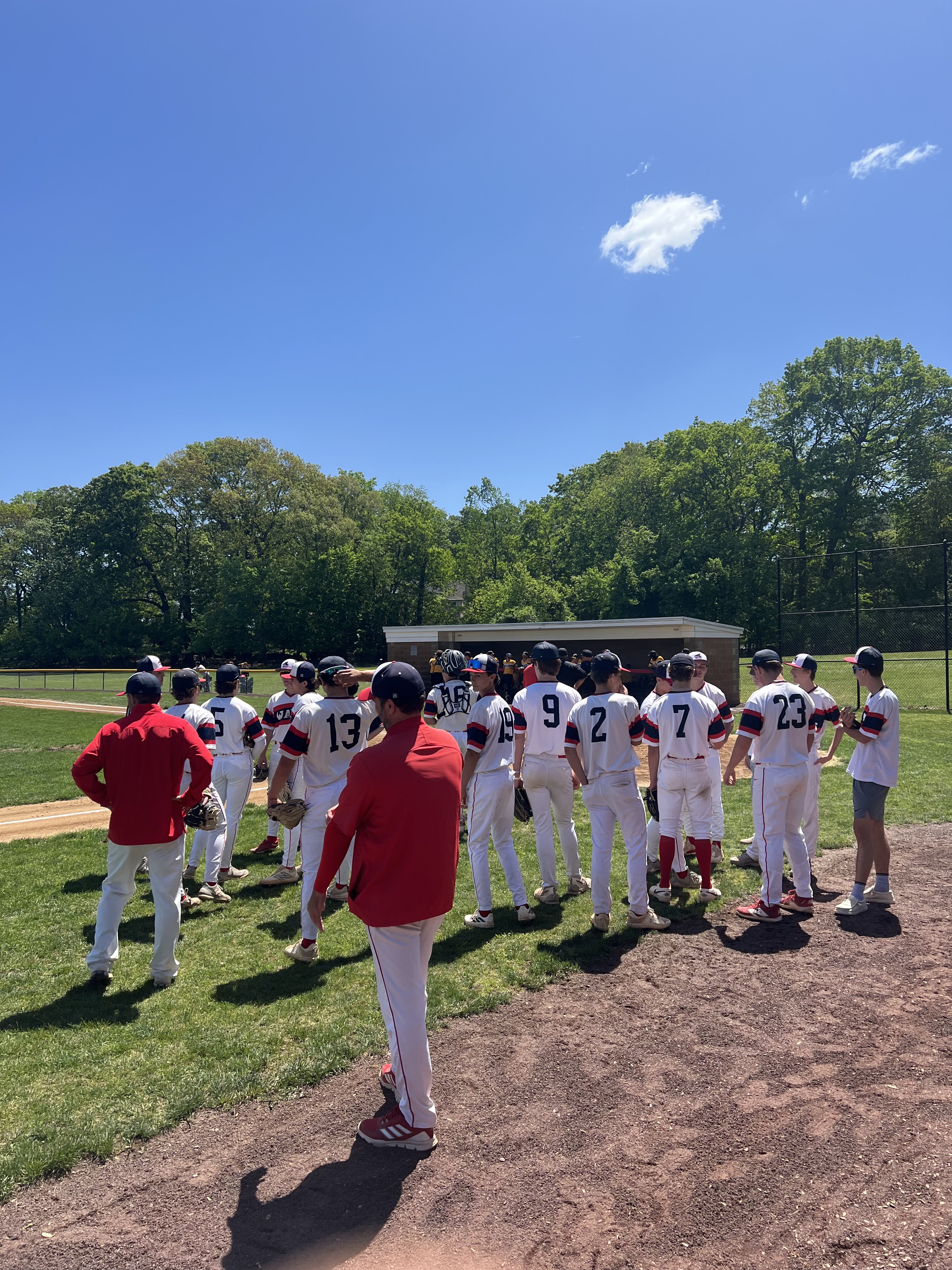 WHS Baseball plays in white uniforms on field