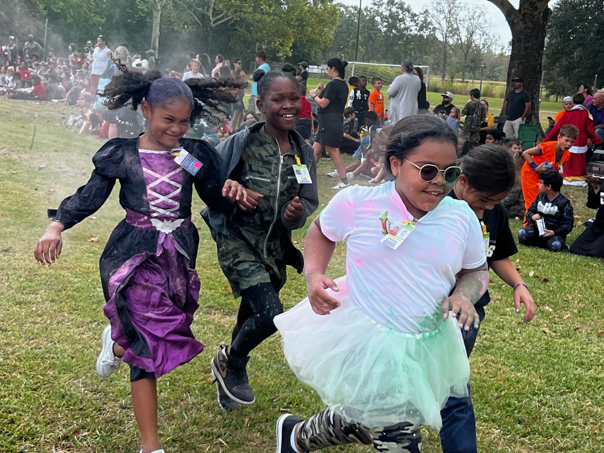 Girls running through powdered color during the Monster Run. 