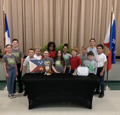 group of students standing behind table