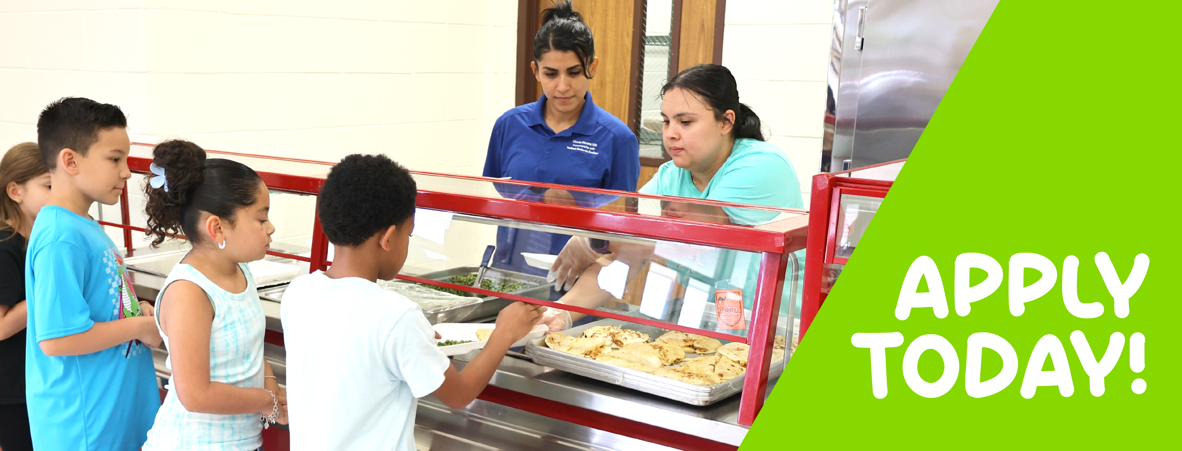The image shows a group of people, likely students, standing in front of a food counter with various baked goods on display. The counter has a sign that says "OPEN TODAY" in large green letters.