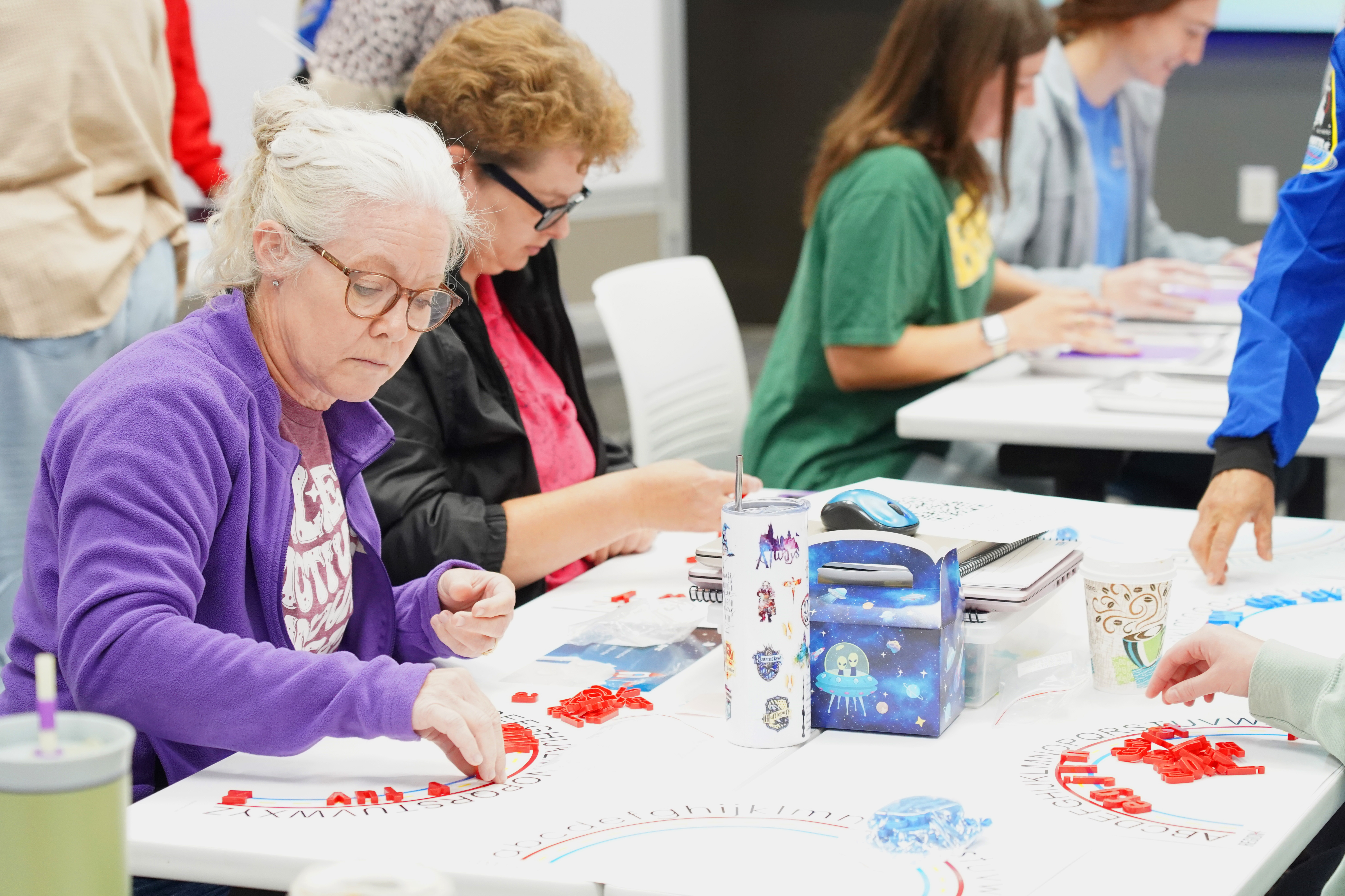 Women work on project together during Reading Academy