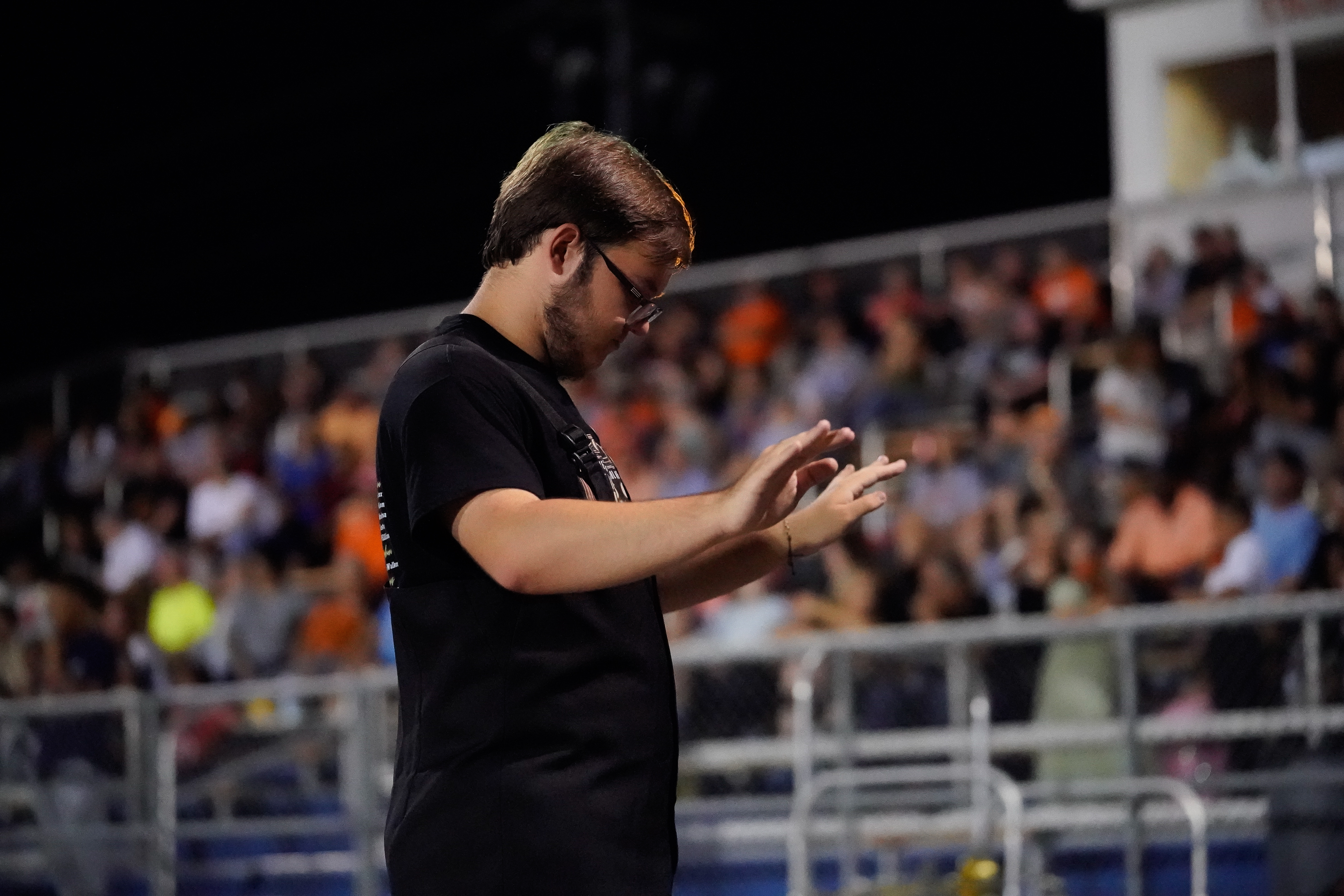 Fayetteville High School band drum major conducts during the homecoming game, leading the crowd in music.