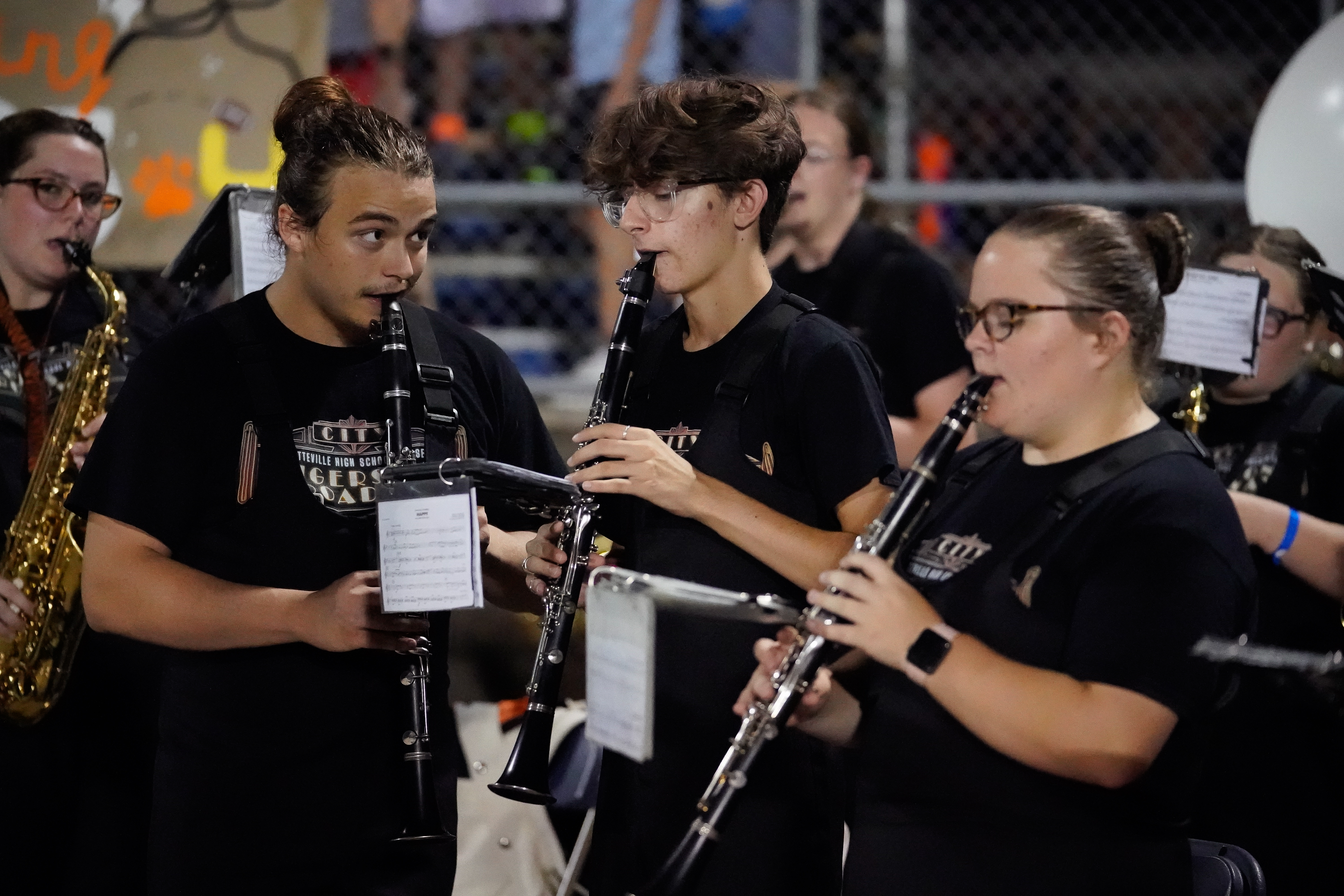 Fayetteville High School band members play clarinets in the stands, adding spirit to the homecoming game.