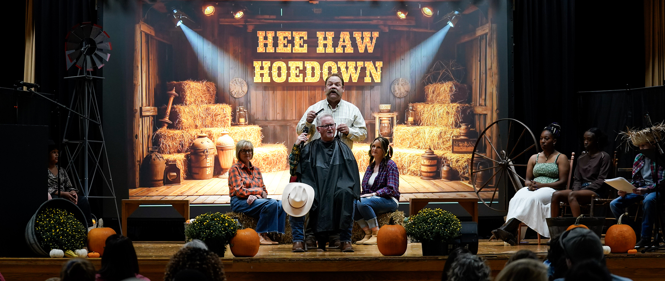 actor in barber's chair with barber standing behind him on stage in Hee Haw scene