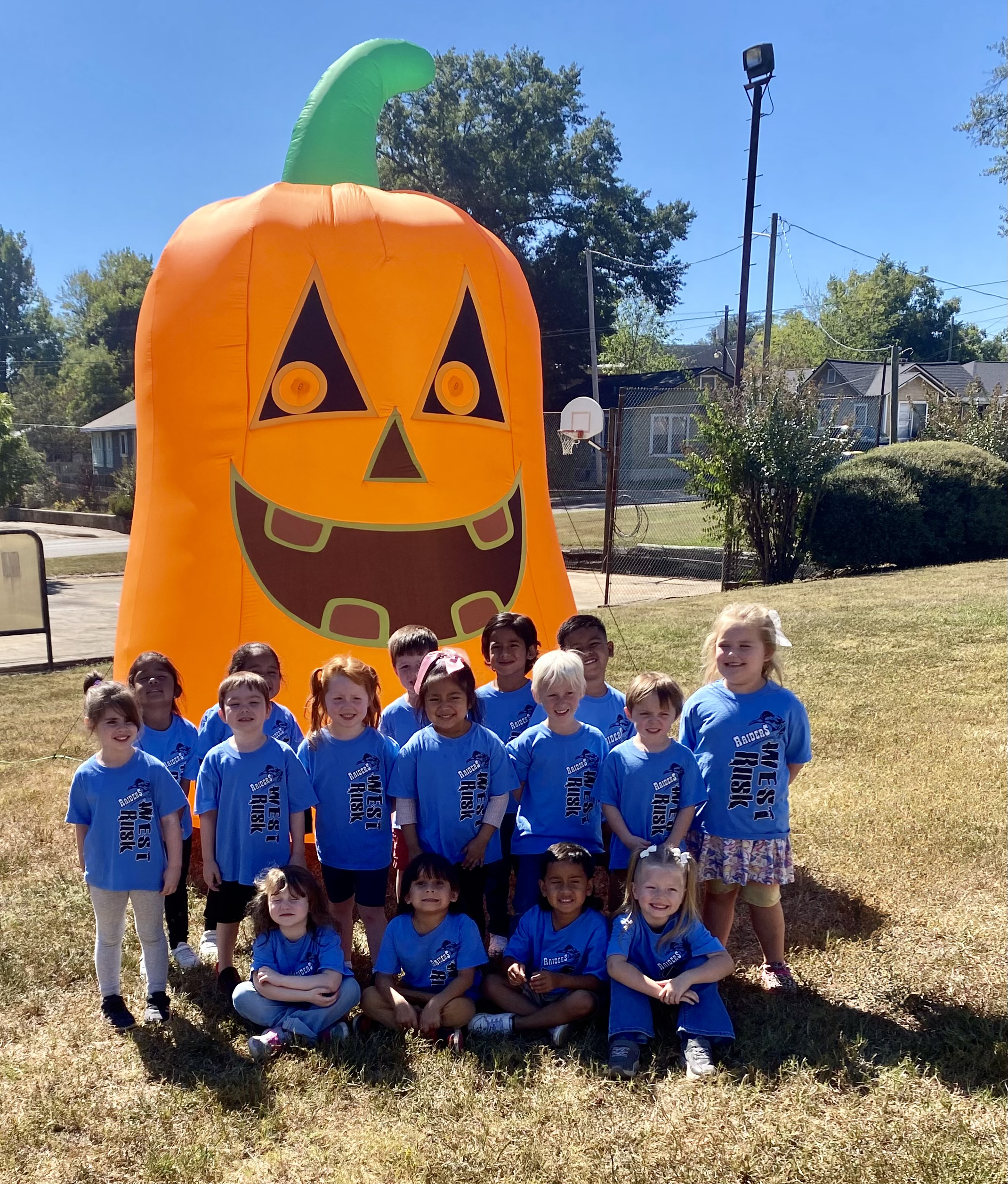 West Rusk Elementary Pre-K students in front of a inflatable pumpkin