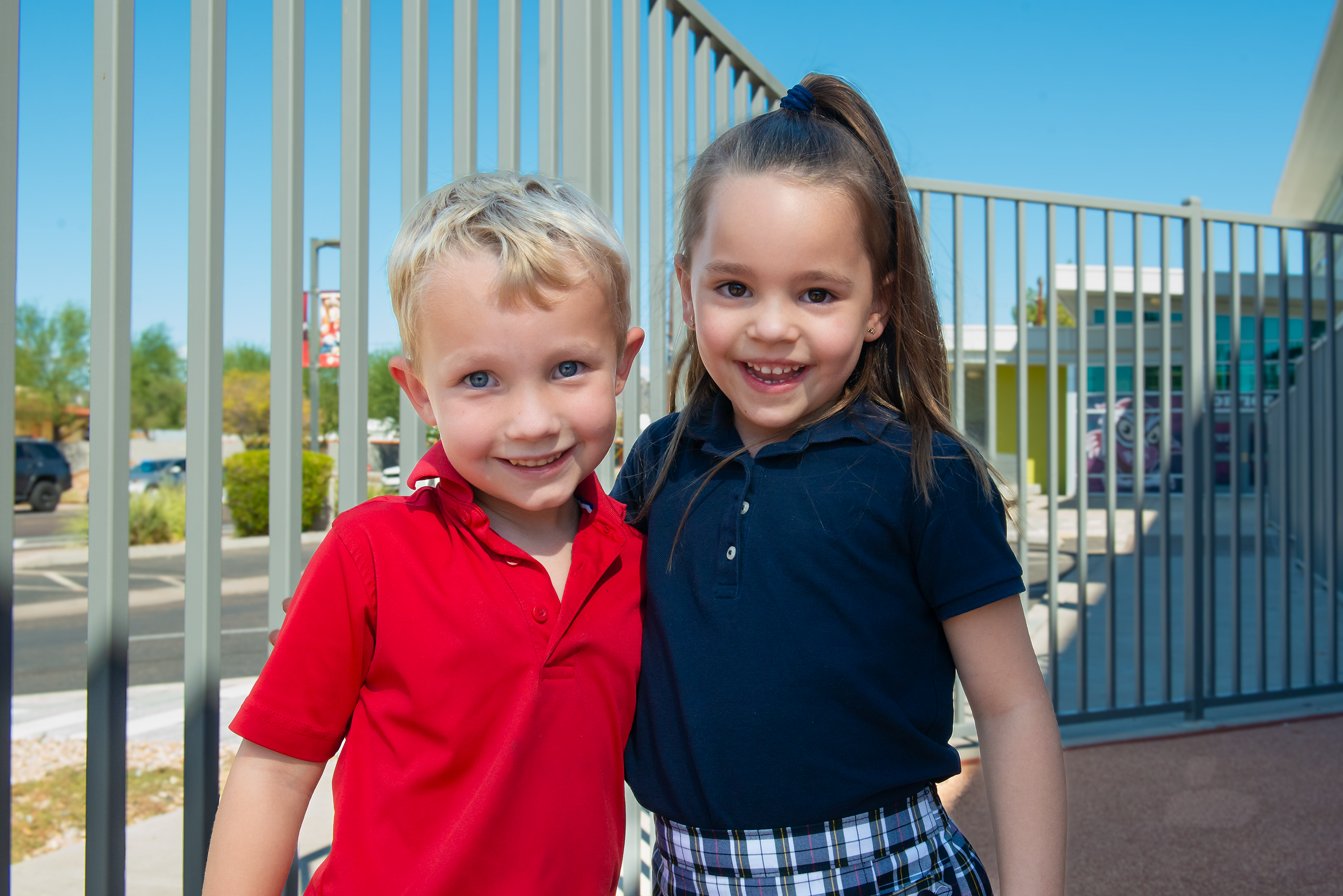 two students smiling together at recess