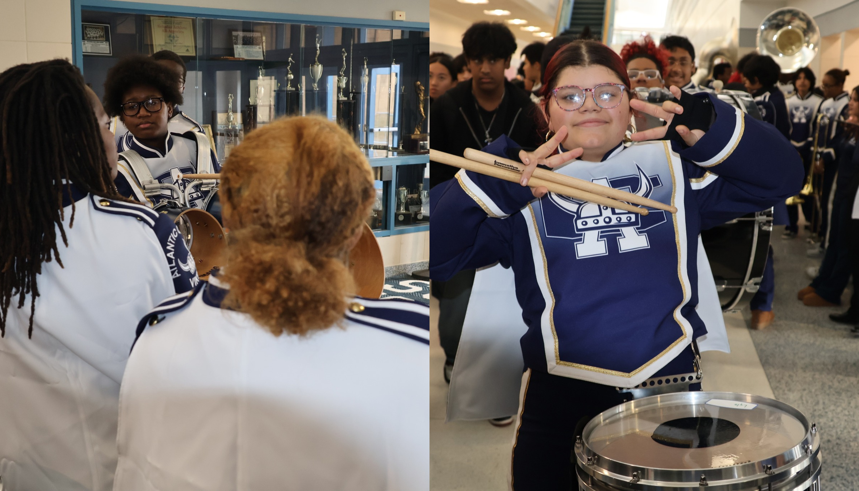 A group of people, some wearing uniforms, are gathered in a hallway, with one person playing a drum.