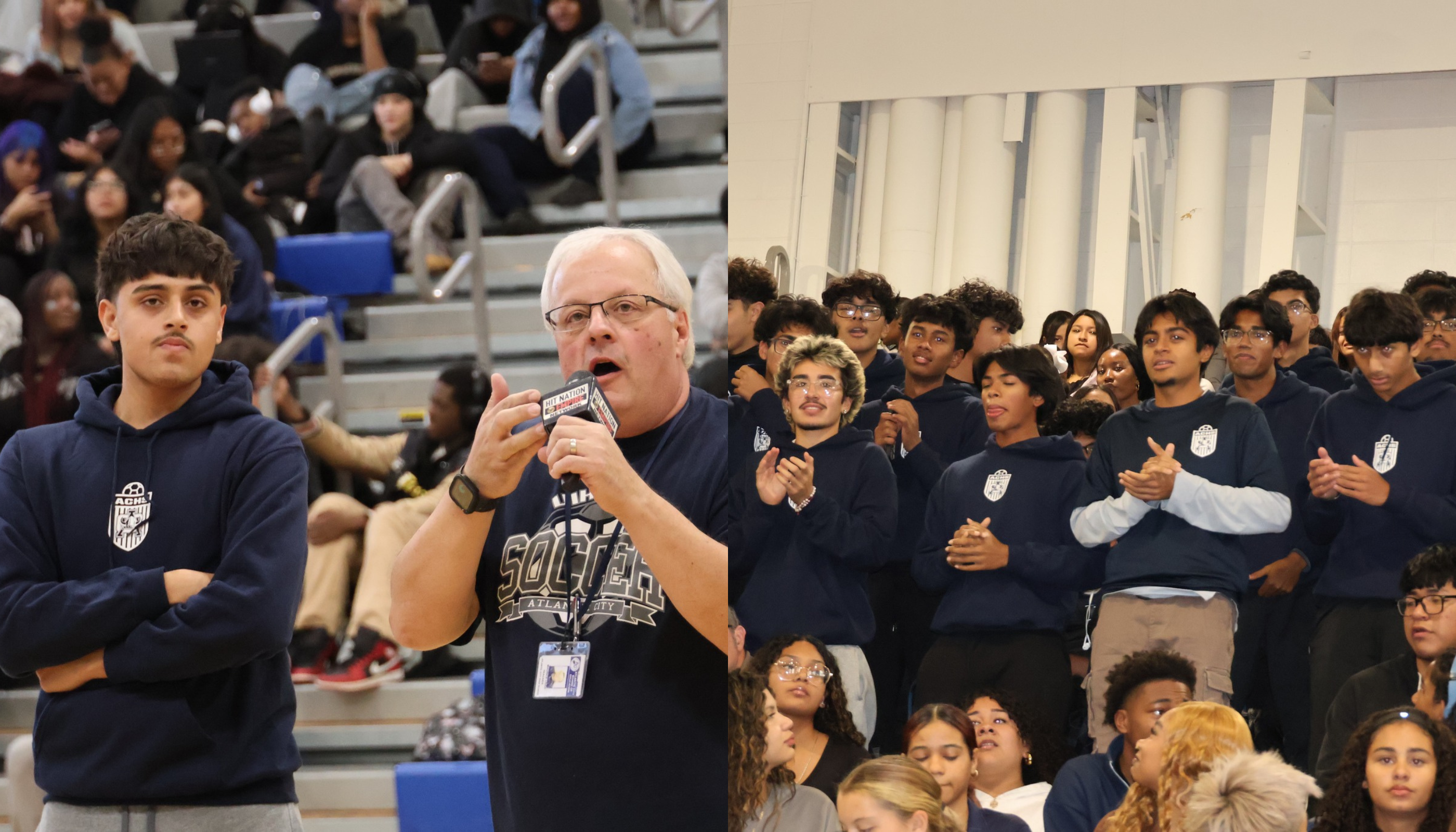 A large group of people, mostly wearing navy blue uniforms, are gathered in an indoor setting, with a man speaking into a microphone in the foreground.