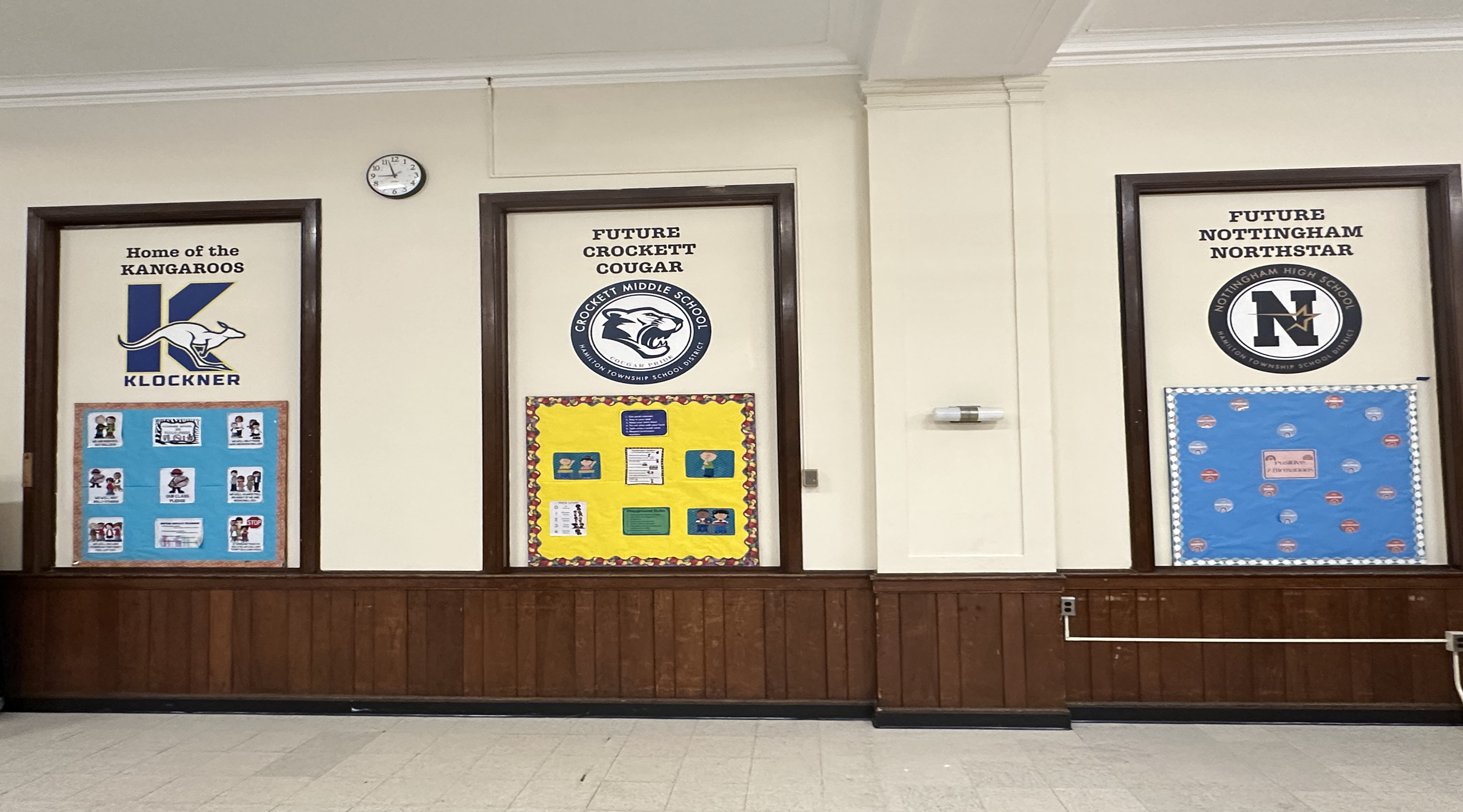 The image shows three bulletin boards or displays in a school hallway, featuring various logos, text, and decorations related to the school's future programs and activities.