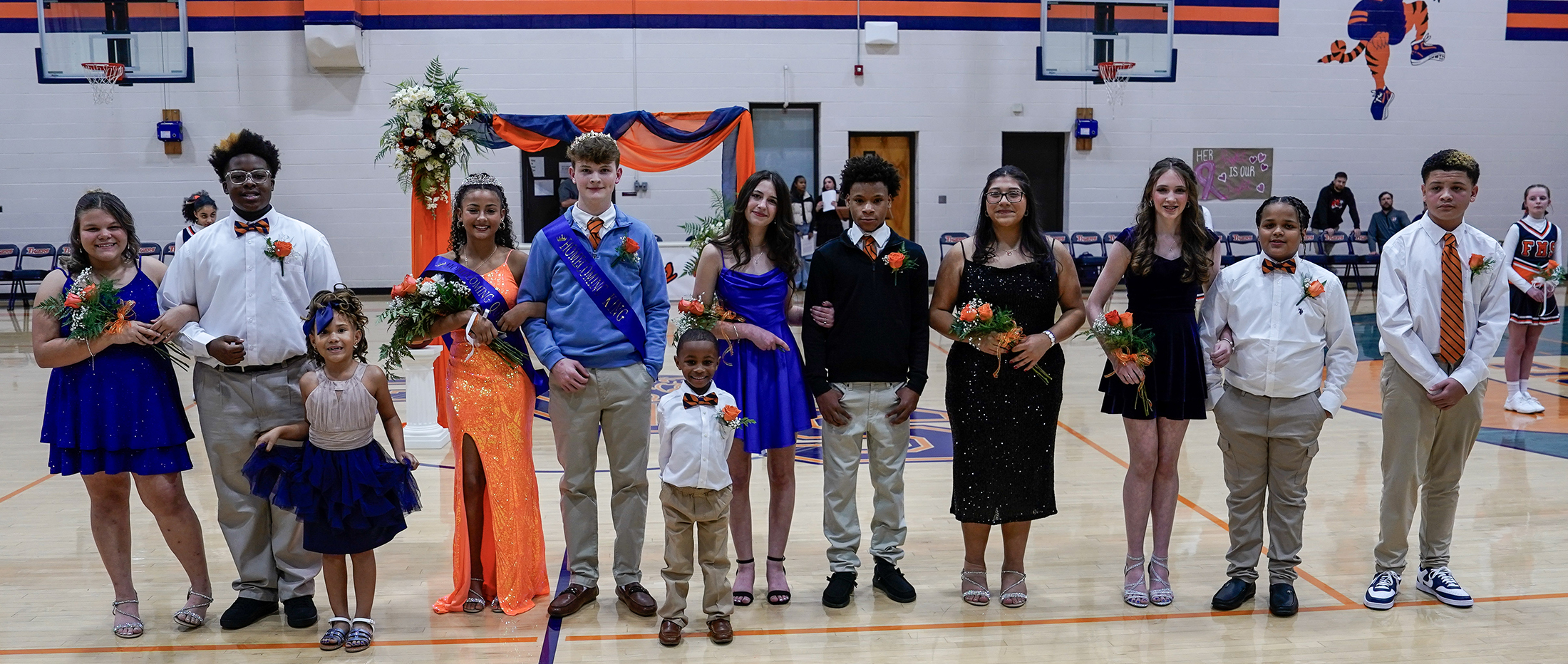 middle school students in homecoming court lined up on gym floor