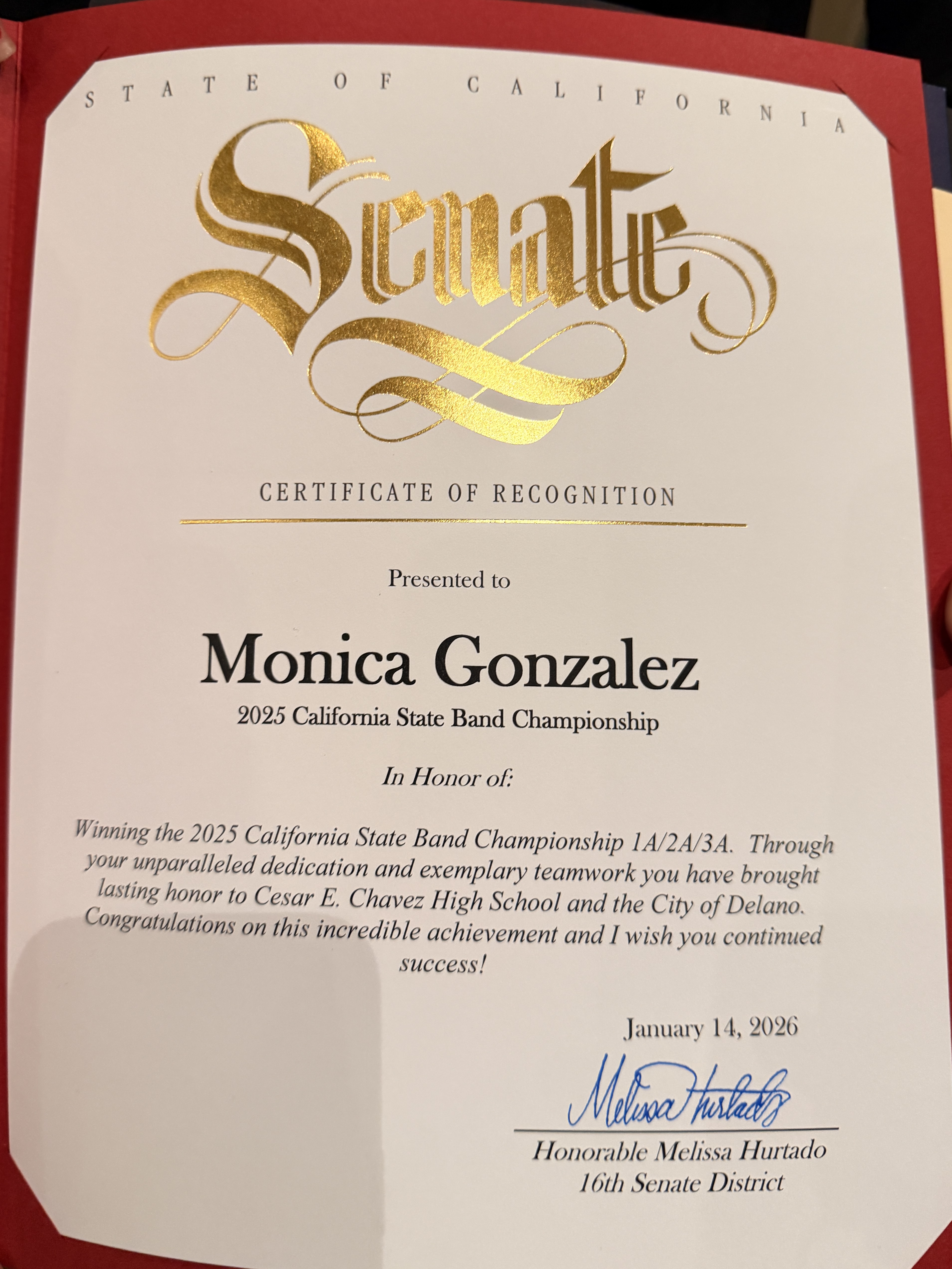 The image shows a certificate of recognition presented to Monica Gonzalez for winning the 2023 California State Band Championship, with the State of California seal and ornate text in the background.