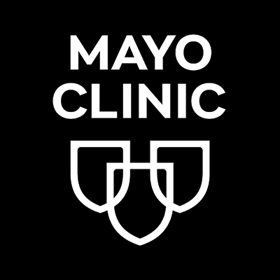 The image displays the text "MAYO CLINIC" in large white letters against a black background, with a logo consisting of three shield-shaped symbols below the text.
