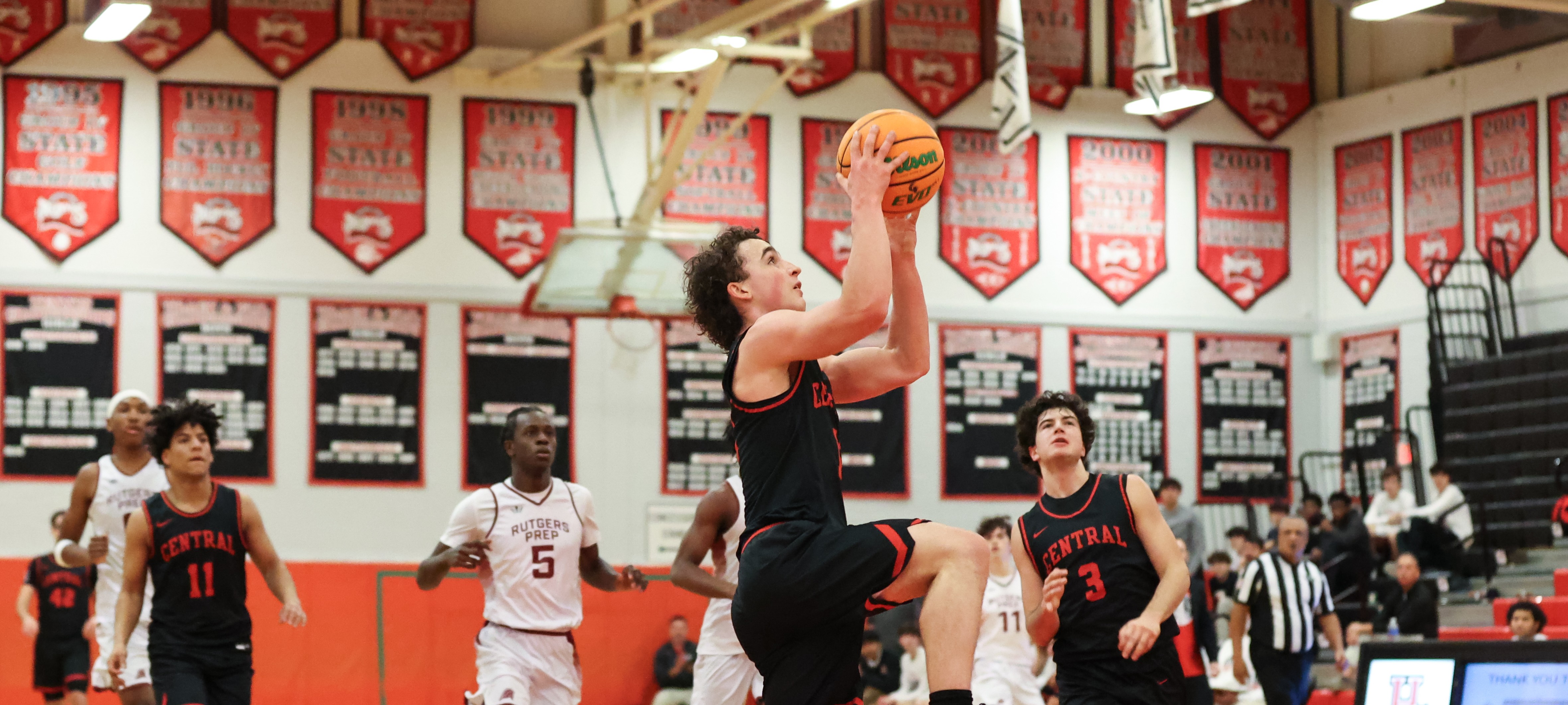 photo of boys basketball player making a shot