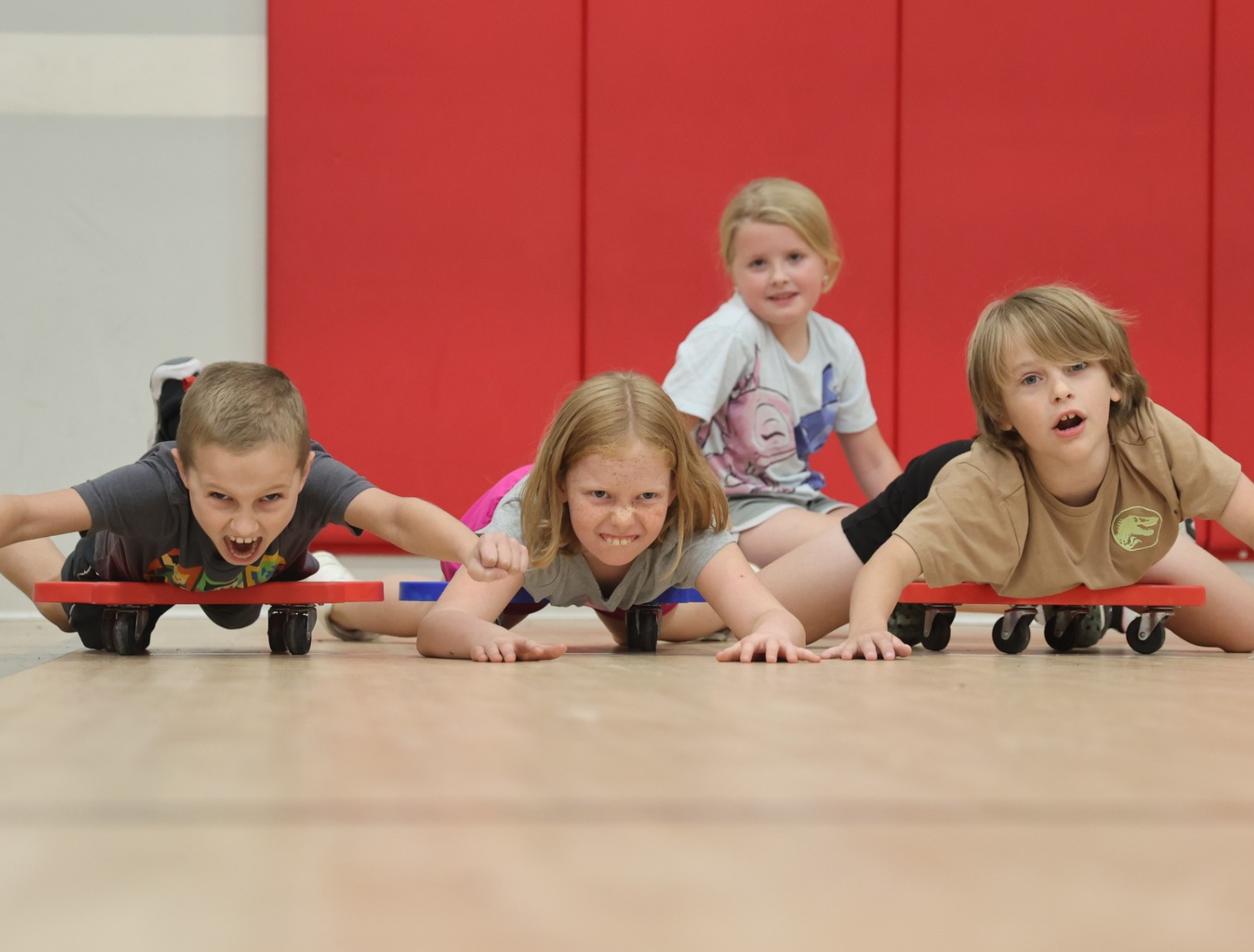 studnets on scooters in gym