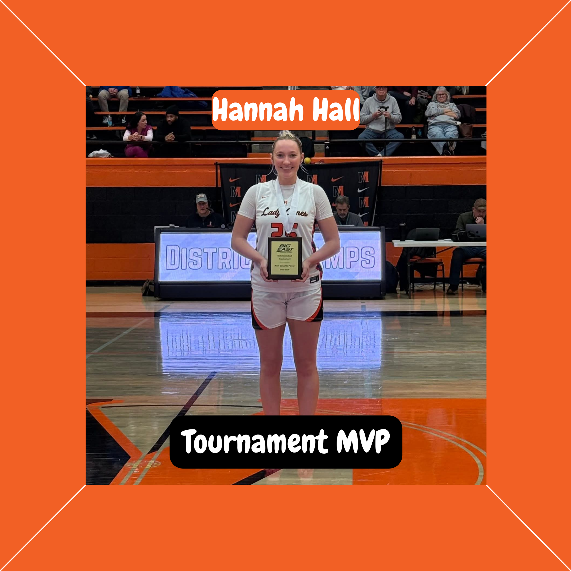 Lady Canes basketball player Hannah Hall stands on the court holding her Tournament MVP award.