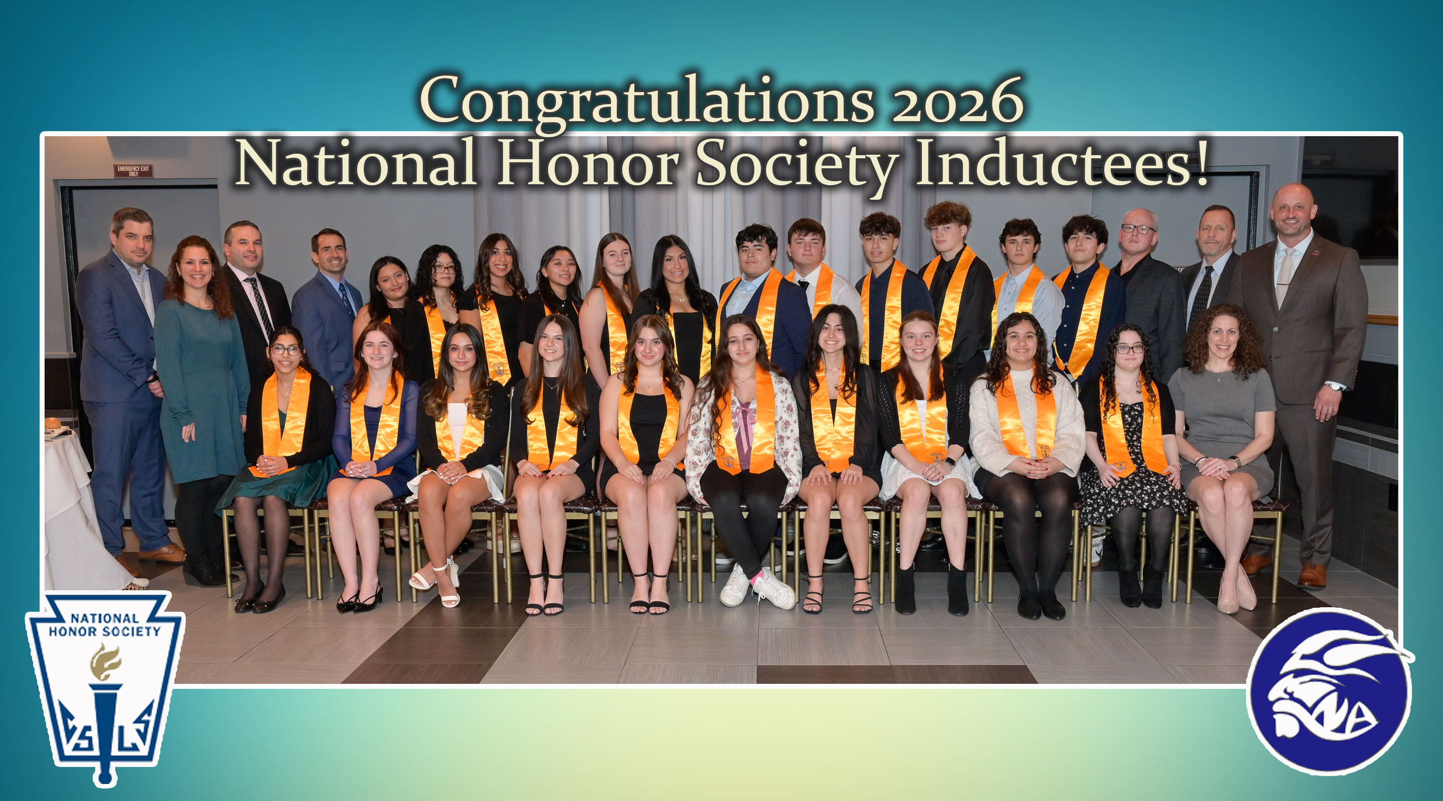 A group of students and adults pose for a photo in front of a banner congratulating National Honor Society inductees, with the National Honor Society logo in the bottom left and a school logo in the bottom right.