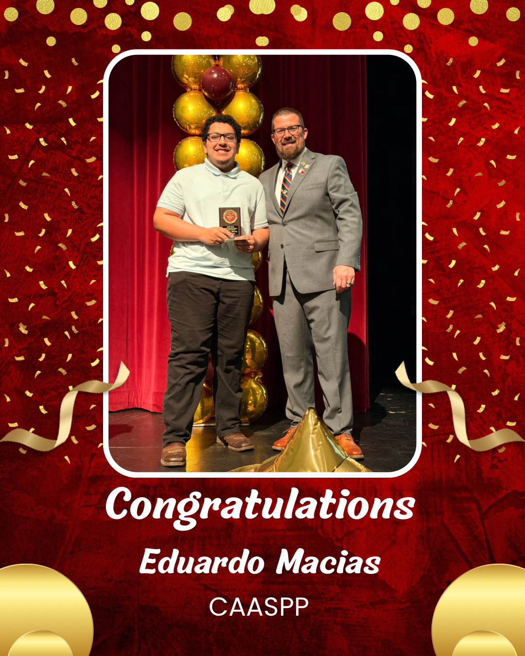 The image shows two men standing on a stage, one of whom is holding a certificate and shaking hands with the other. The background is a red curtain with yellow confetti falling around them, creating a celebratory atmosphere.