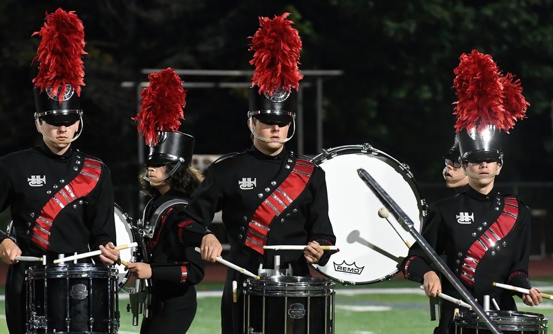 marching  band drummers in red and black uniforms