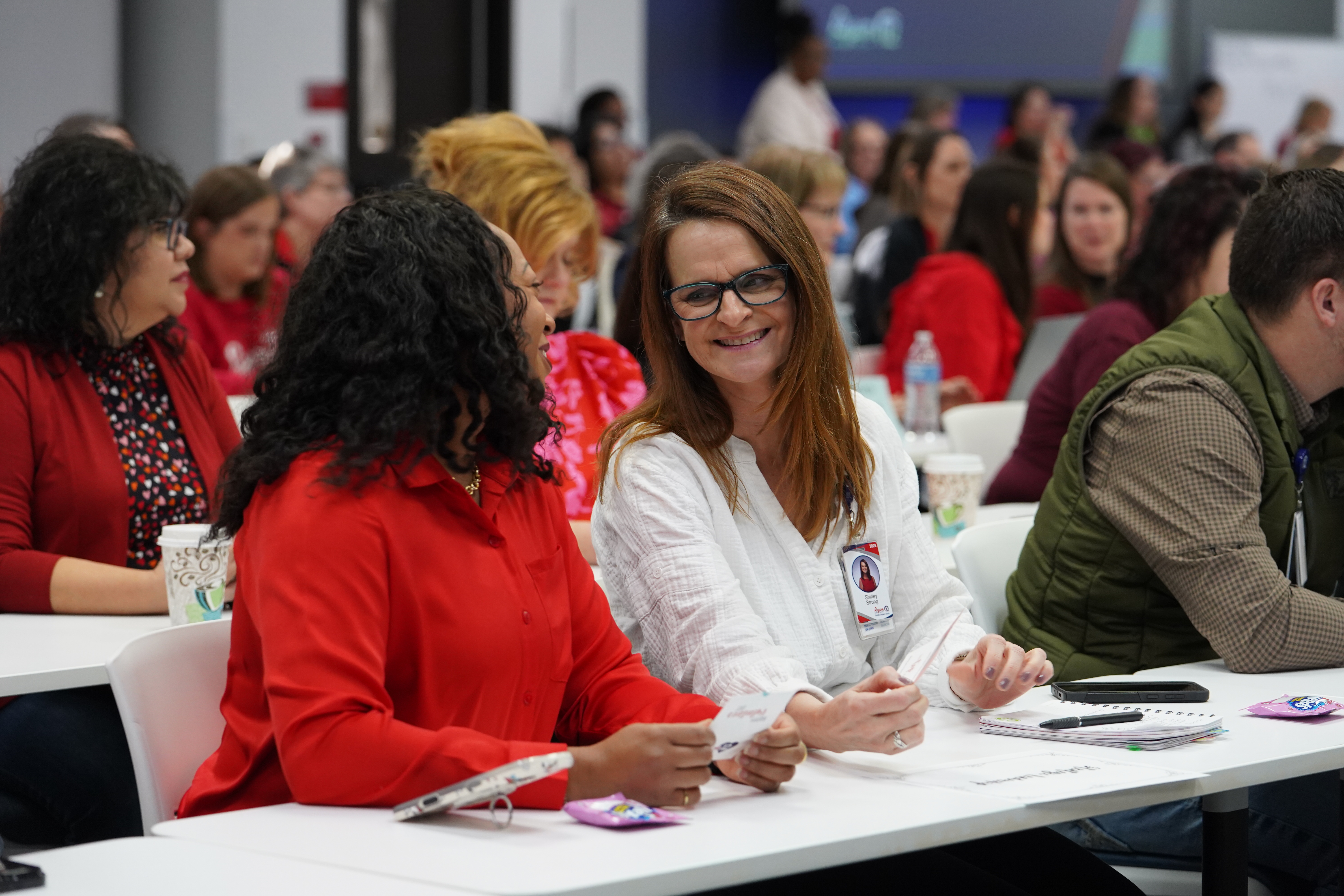 ESC Staff laughs and talks together during monthly staff meeting