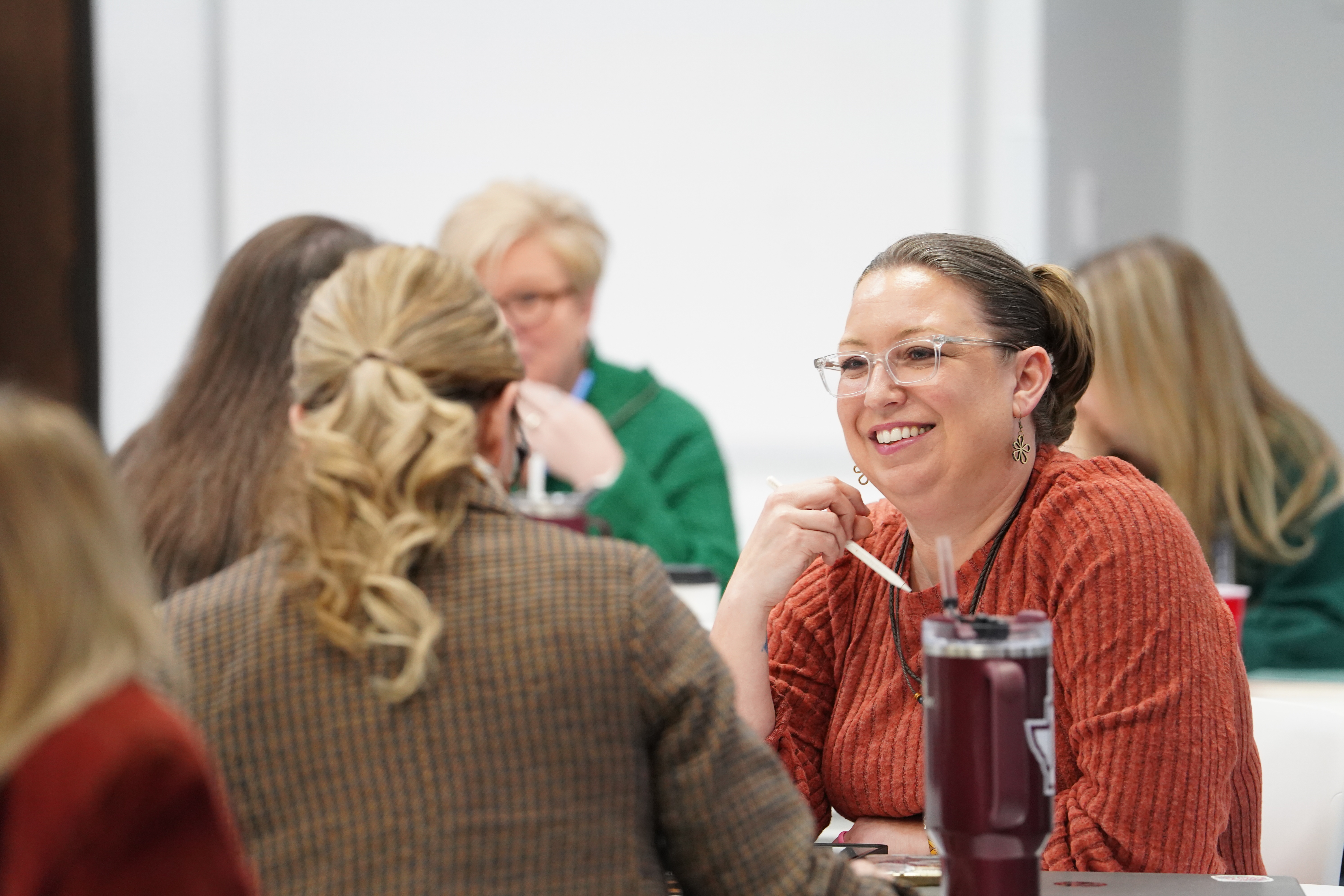 A group of women engage in meaningful conversation during a training session
