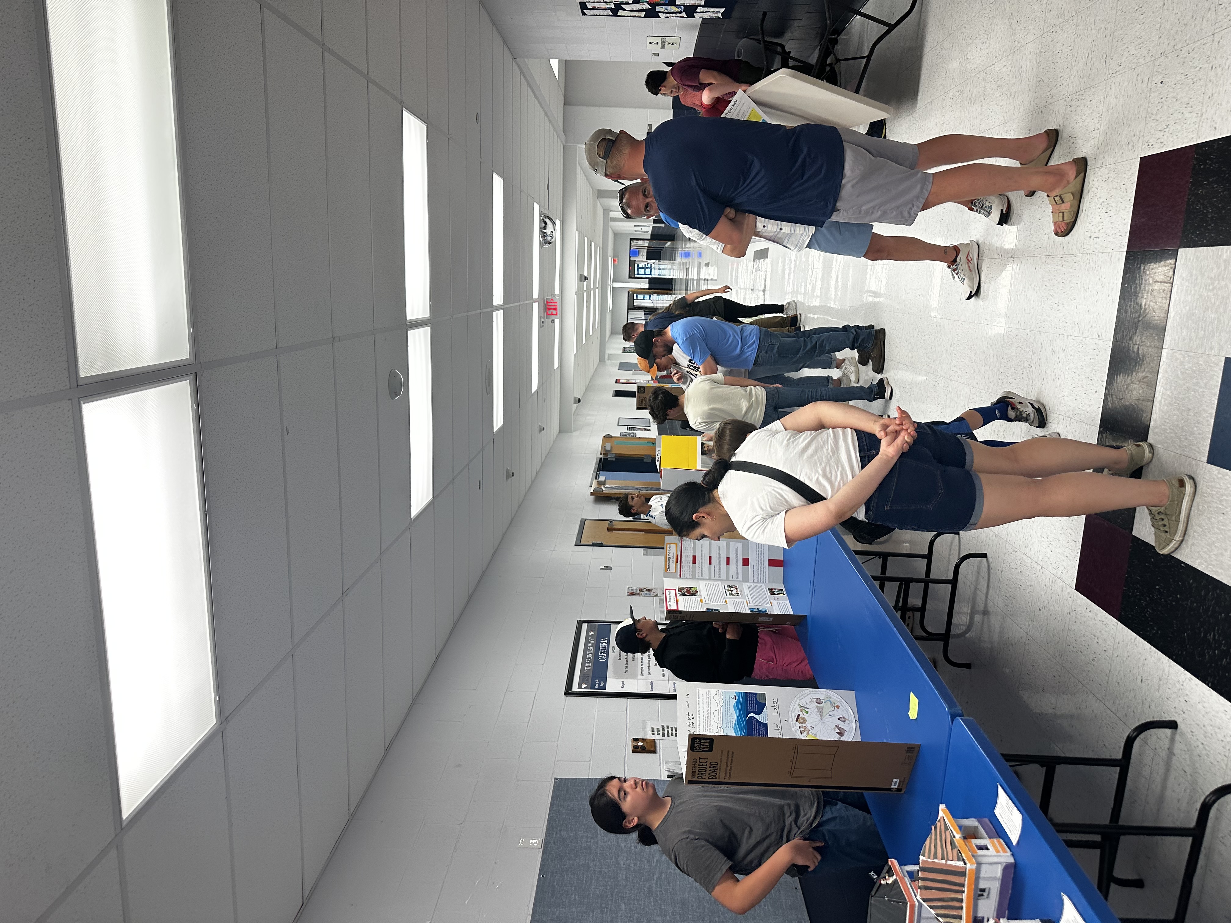 Students line the halls at Frontier Middle School to show off their projects and receive feedback from parents.