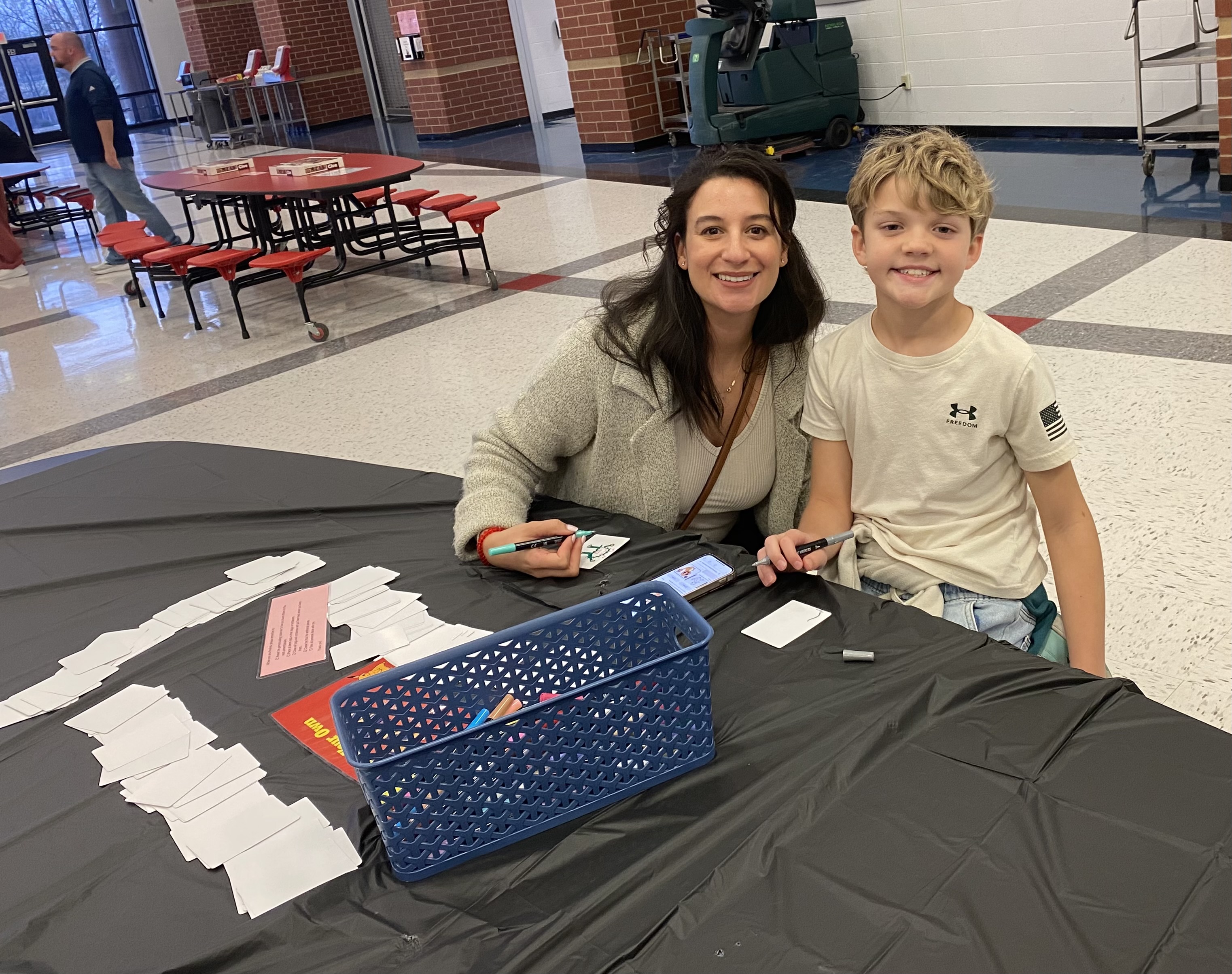 Family being creative while creating Pokemon cards at the Horizons Family Night